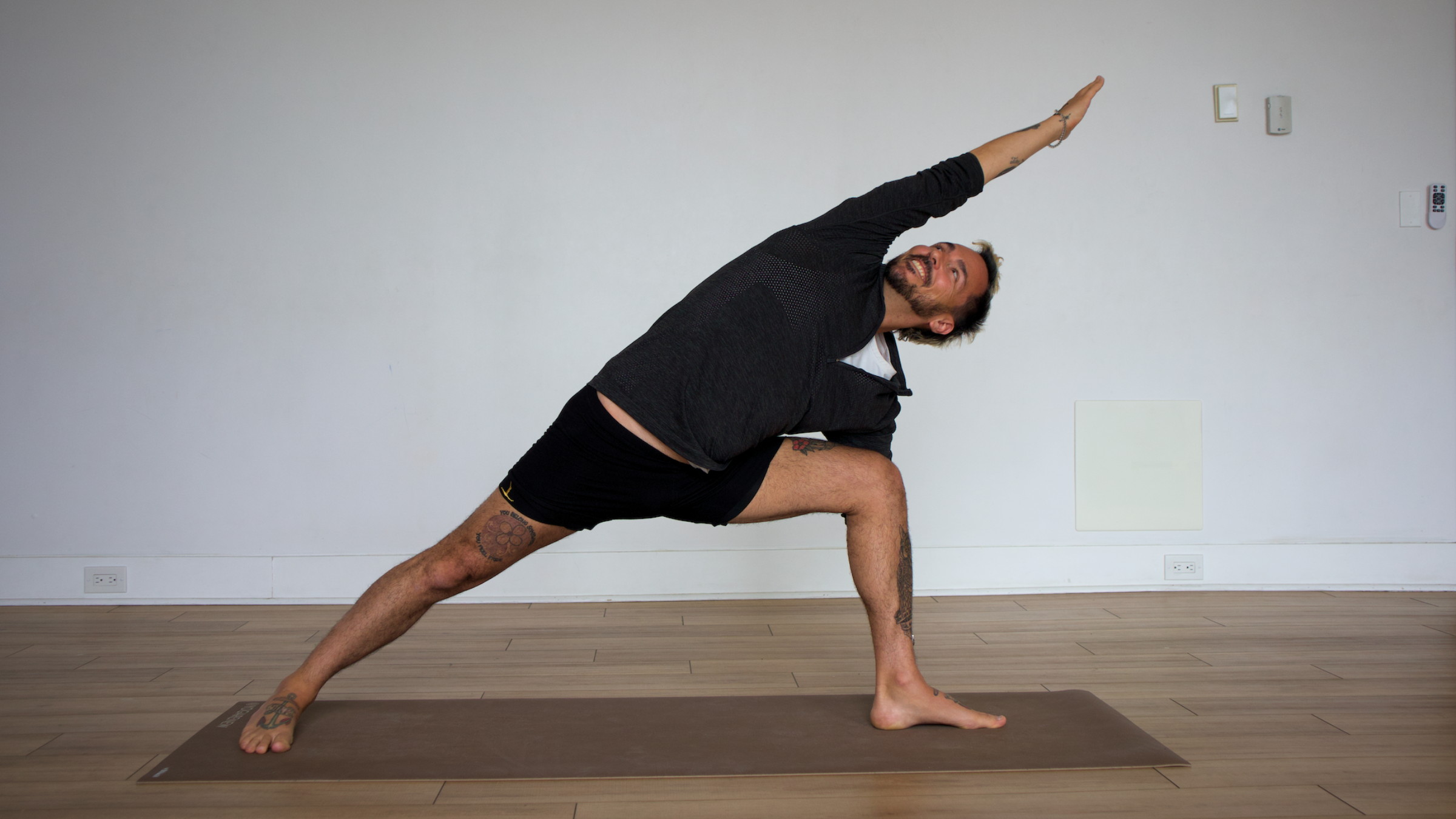 man in extended side angle yoga pose