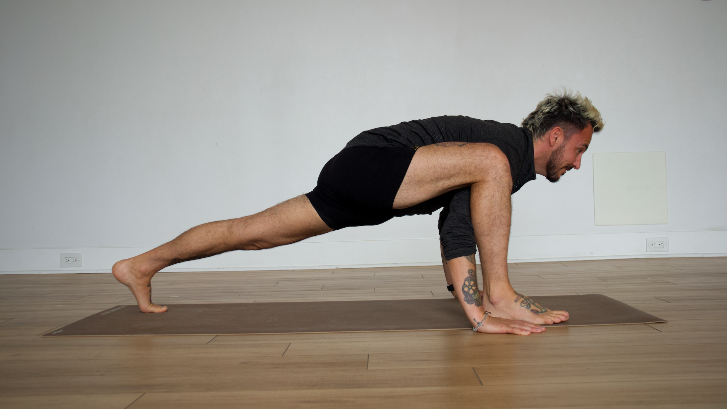 Man in Lizard Lunge with Arm Under Leg pose