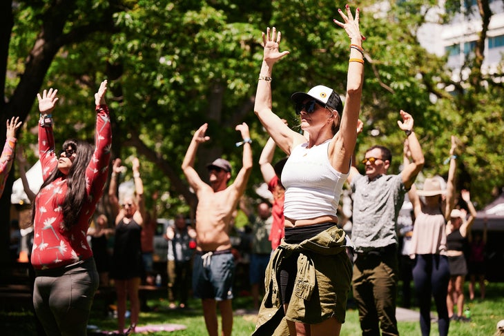 students practicing yoga at the outside festival