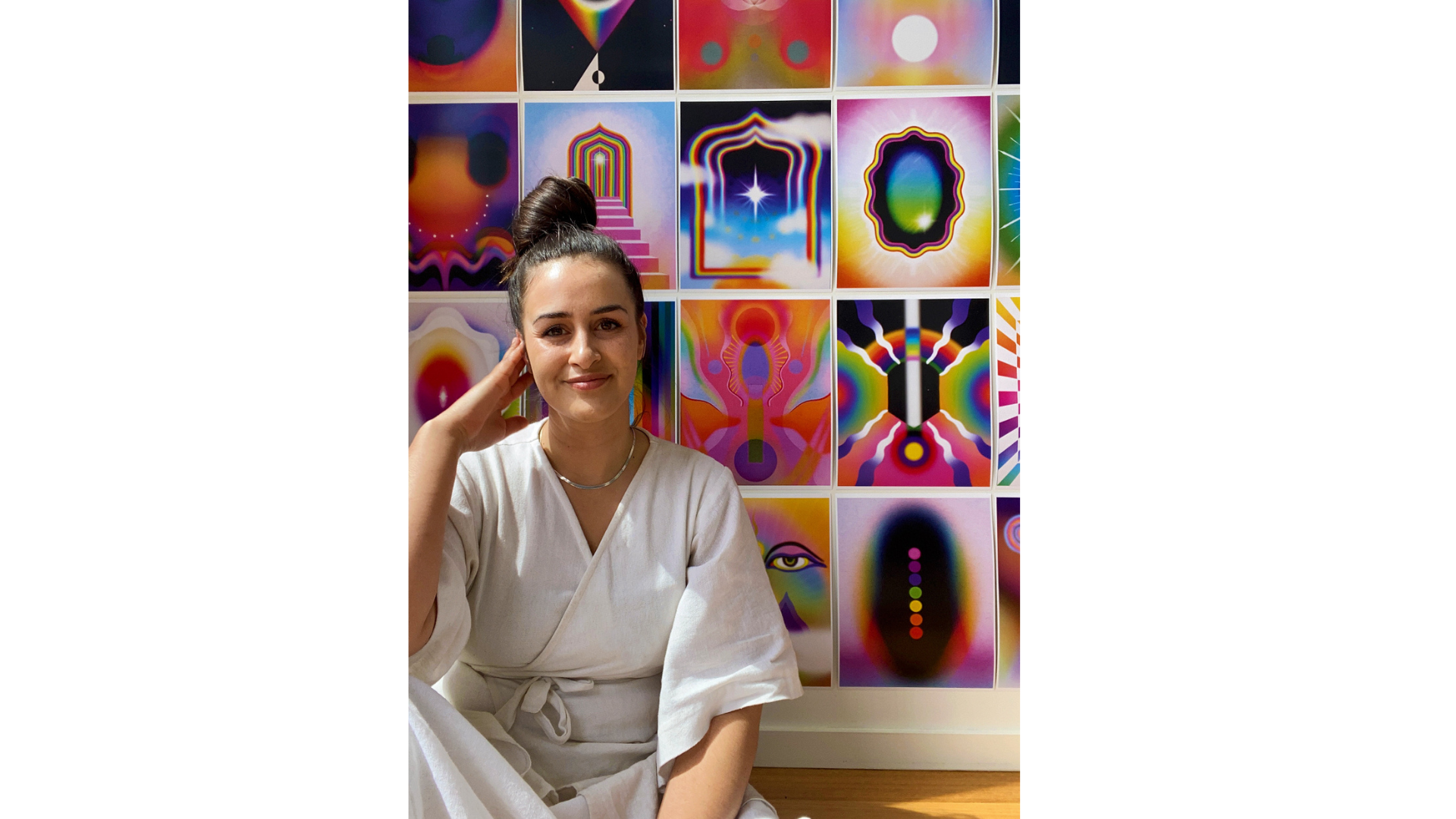 Portrait of artist Delta Venus in front of her artwork