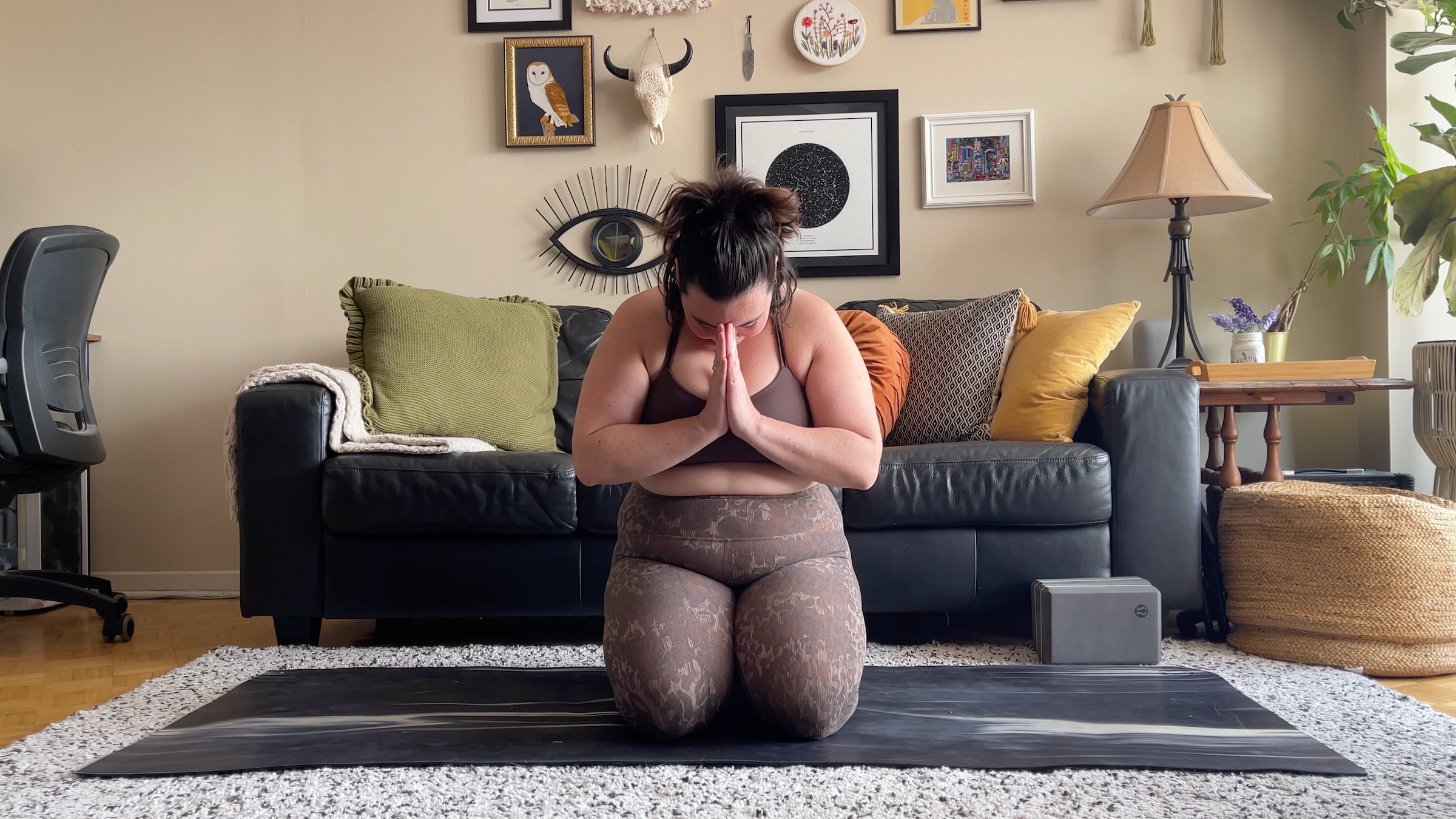 yoga teacher taylor lorenz in kneeling prayer