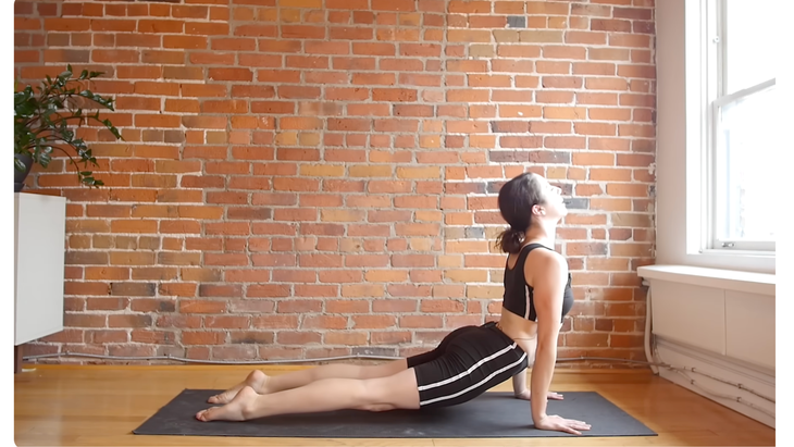 Yoga teacher practicing a backbend during a 10-minute morning yoga stretches with a focus on full-body stretch