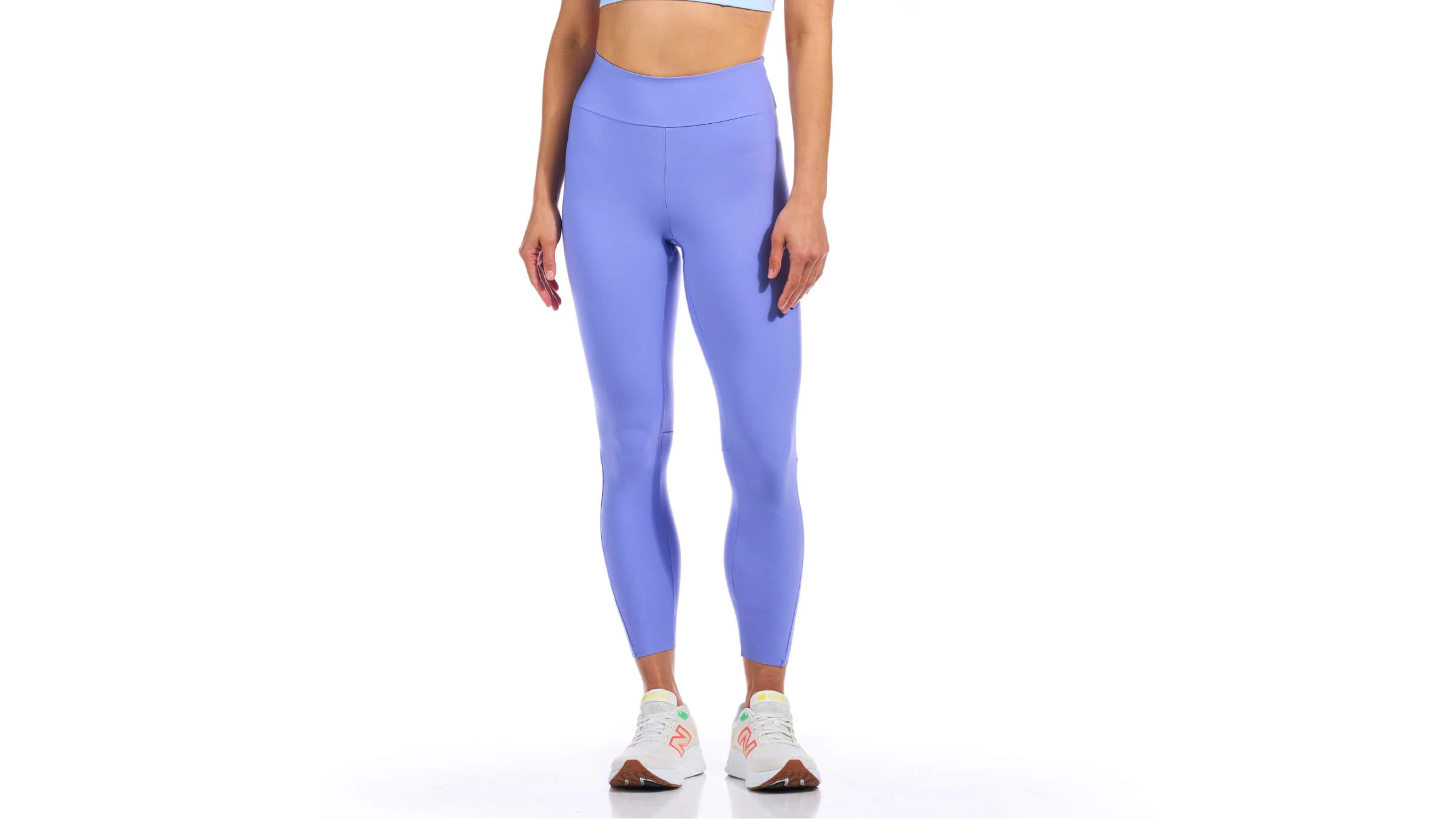 bottom half of woman wearing light purple yoga tights with running shoes