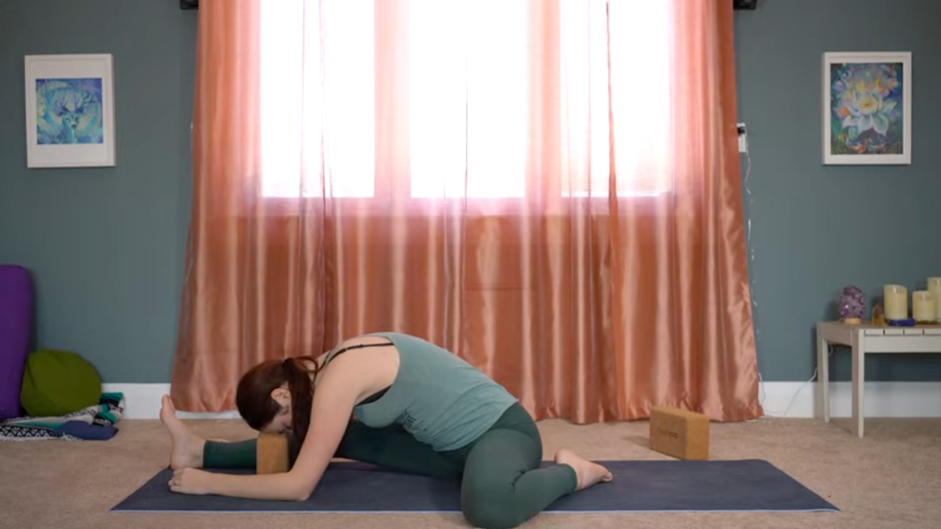 Yoga teacher leaning forward in a yin yoga for hips stretch