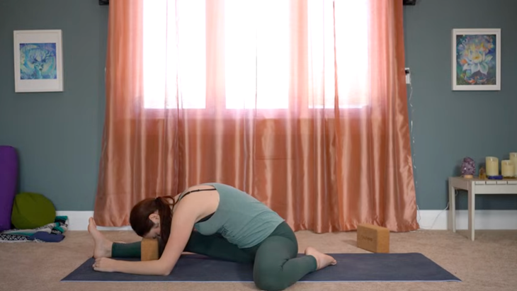 This Yin Yoga for Hips Routine Releases Unwanted Tension 4 Yoga teacher leaning forward in a yin yoga for hips stretch