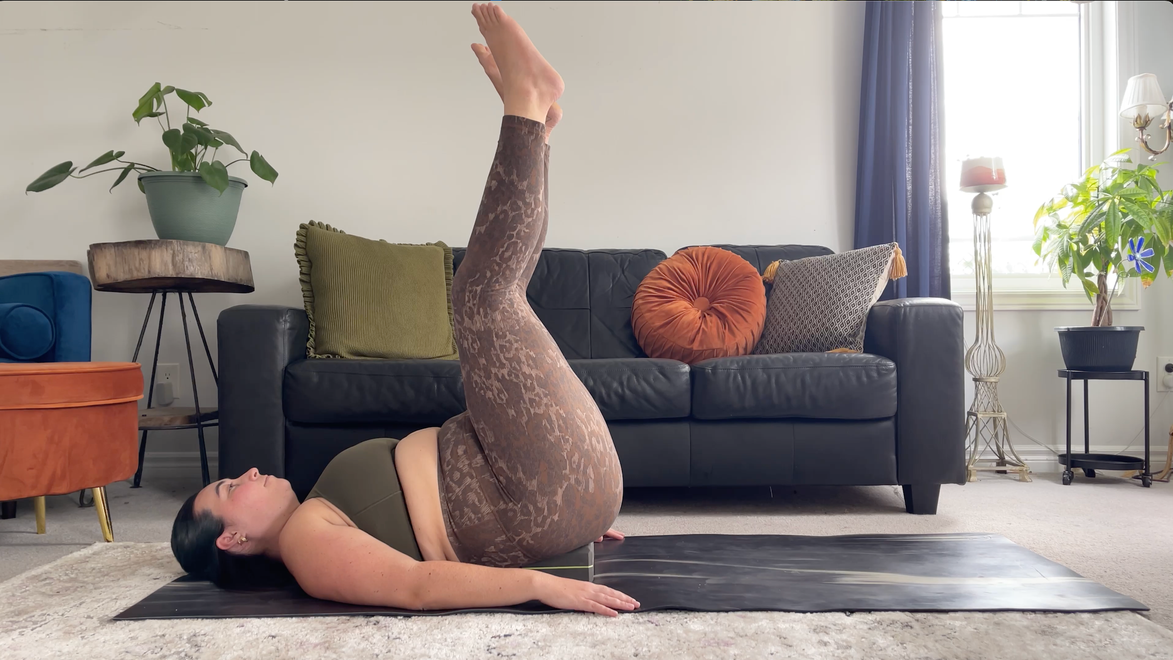 A woman in supported waterfall pose