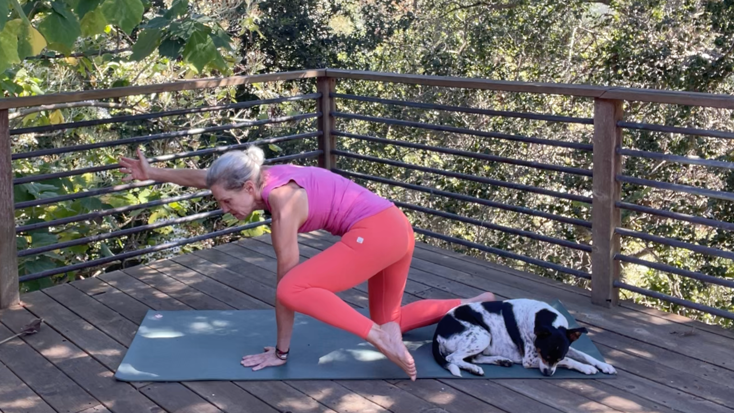 Andrea Marcum practicing her yoga for strength routine on a mat outside