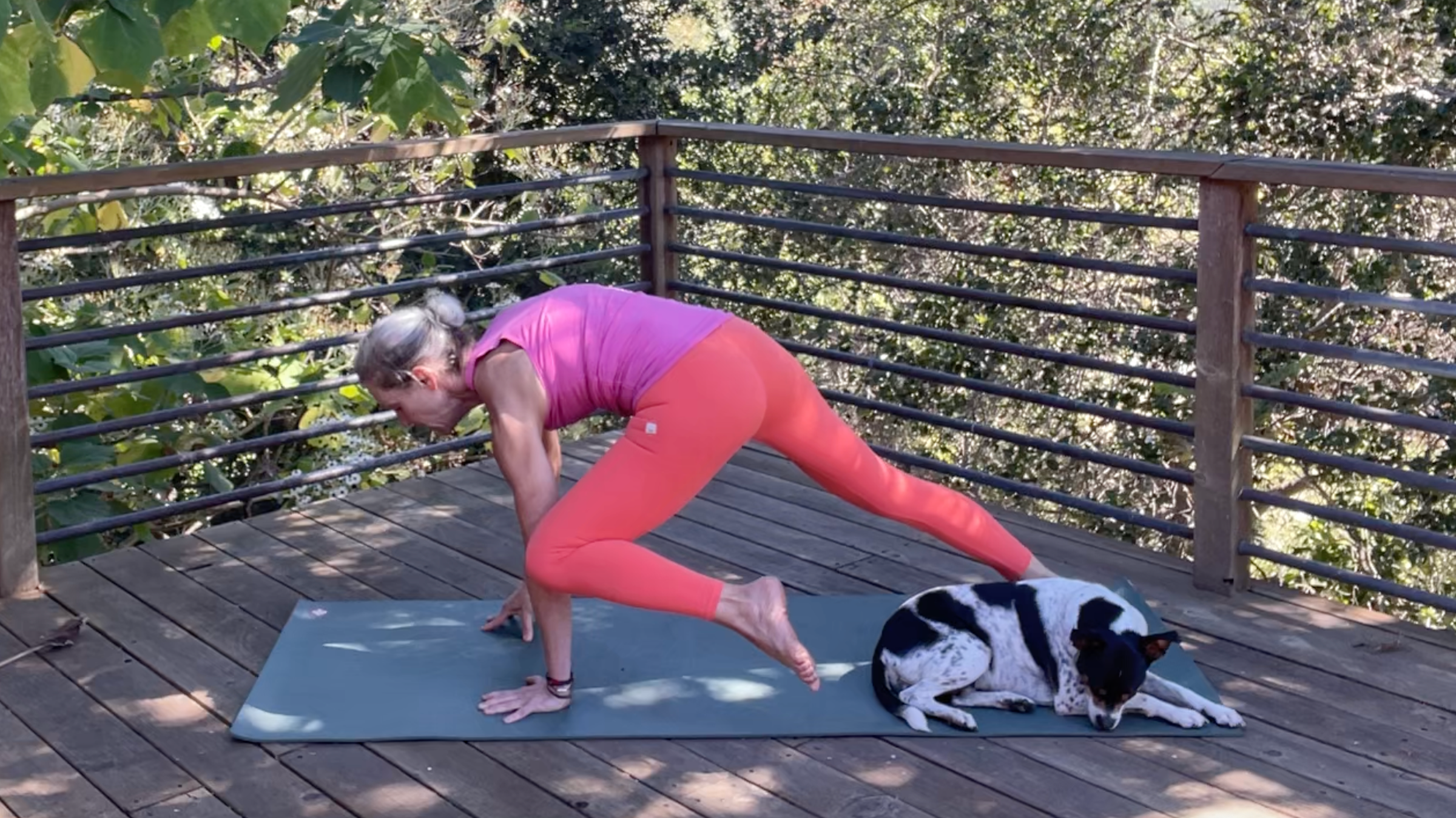 Andrea Marcum practicing her yoga for strength routine on a mat outside