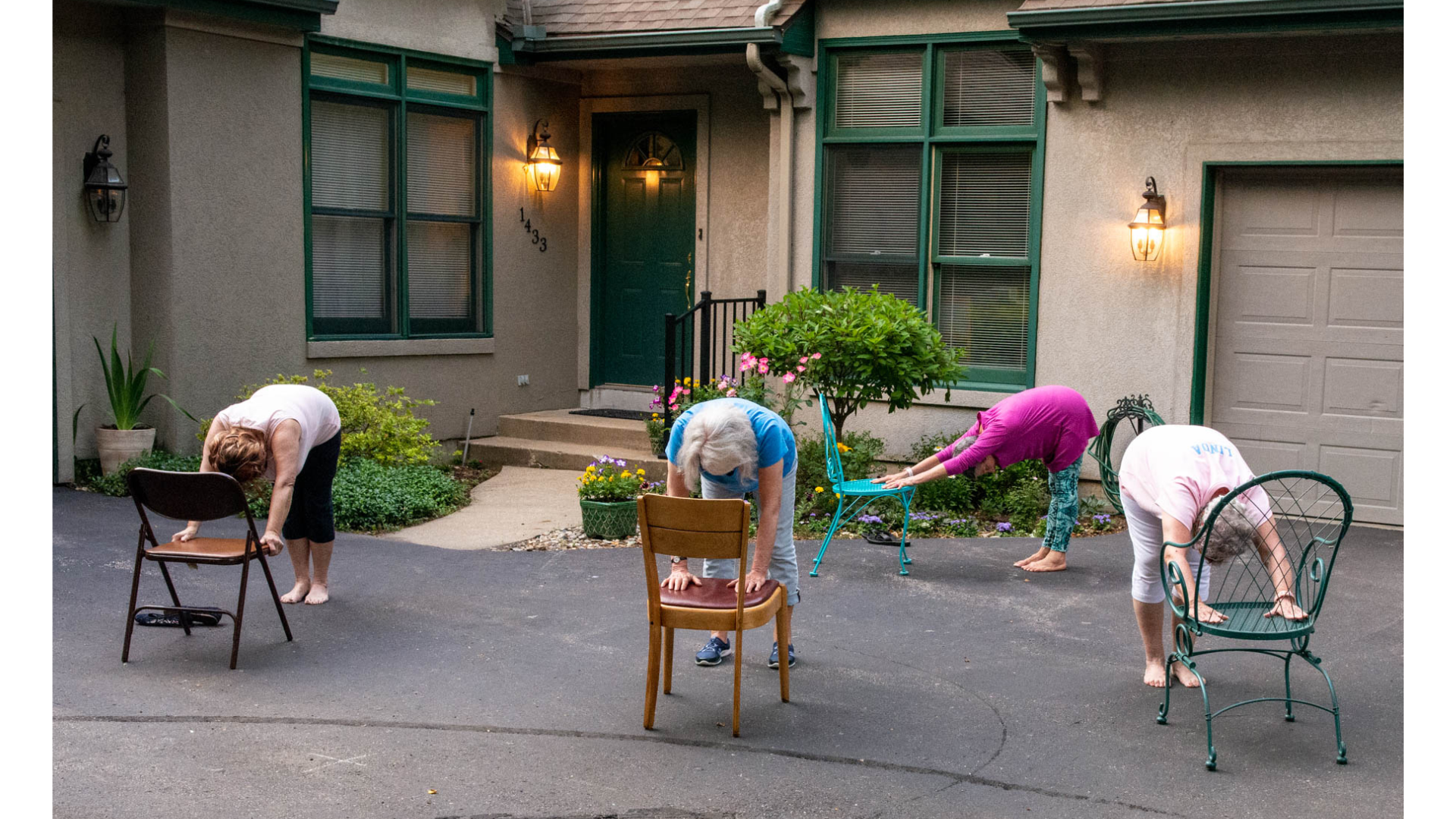 Yoga teacher Marian Hall teaching Downward-Facing Dog pose in a chair yoga class