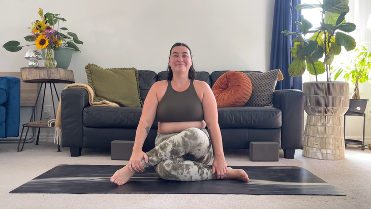 Yoga teacher Taylor Lorenz in Cow Face Pose