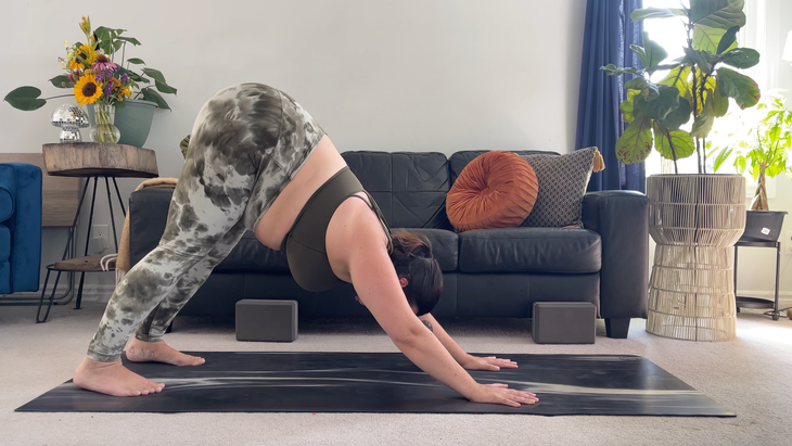 Yoga teacher Taylor Lorenz in Downward-Facing Dog