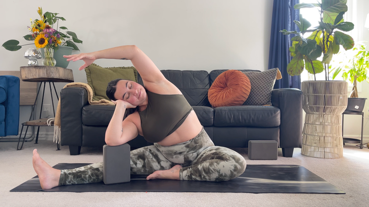 Yoga teacher Taylor Lorenz in Revolved Head-to-Knee in her lazy yoga practice
