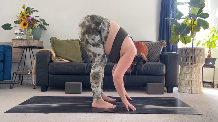 Yoga teacher Taylor Lorenz in Standing Forward Bend