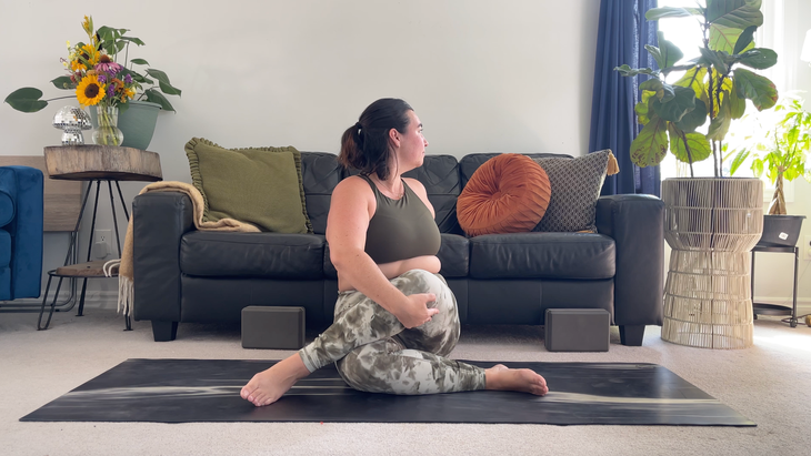 Yoga teacher Taylor Lorenz in Twisting Cow Face in her lazy yoga practice
