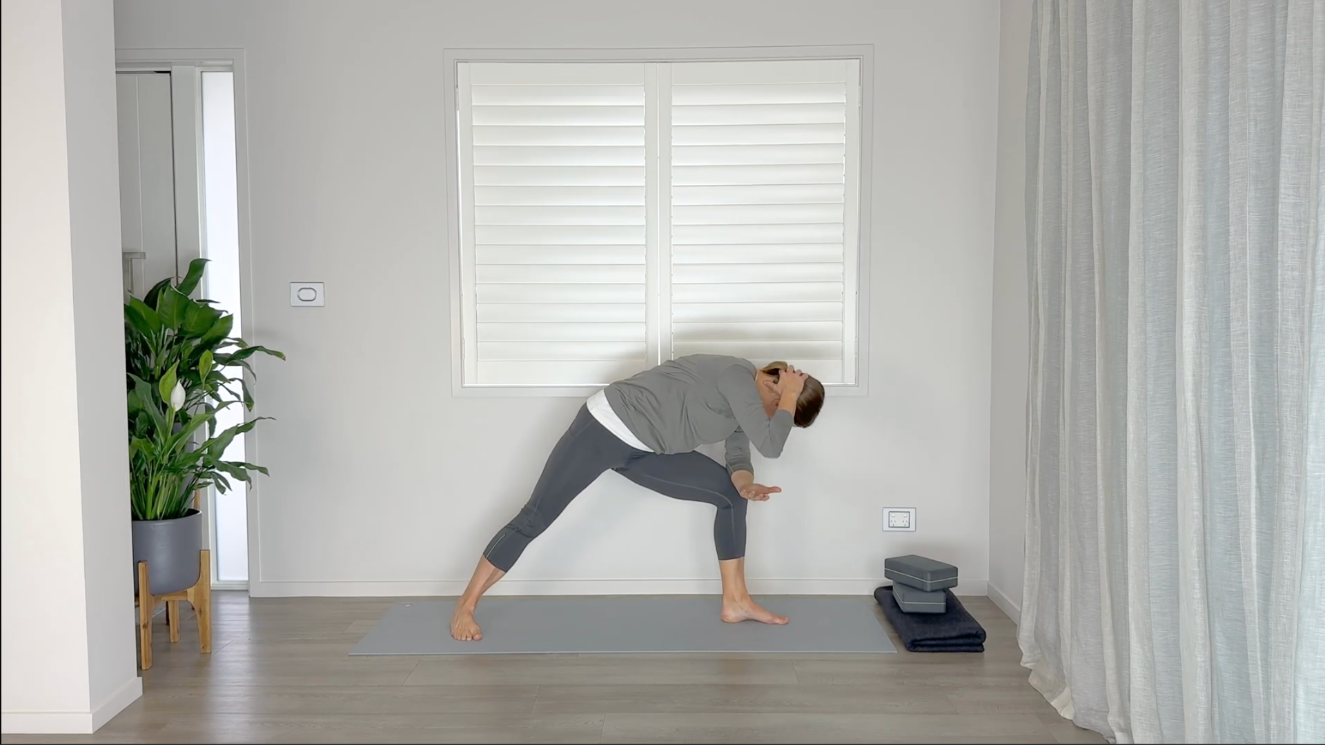 Yoga teacher practicing mid-back stretches 