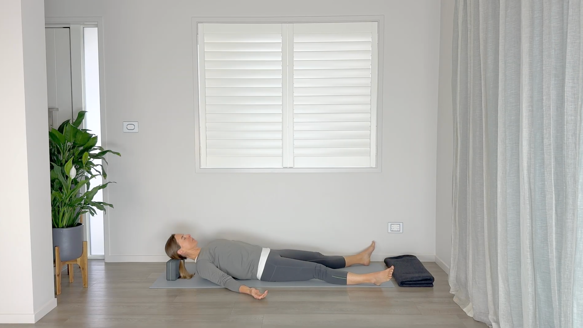 Yoga teacher lying on a mat