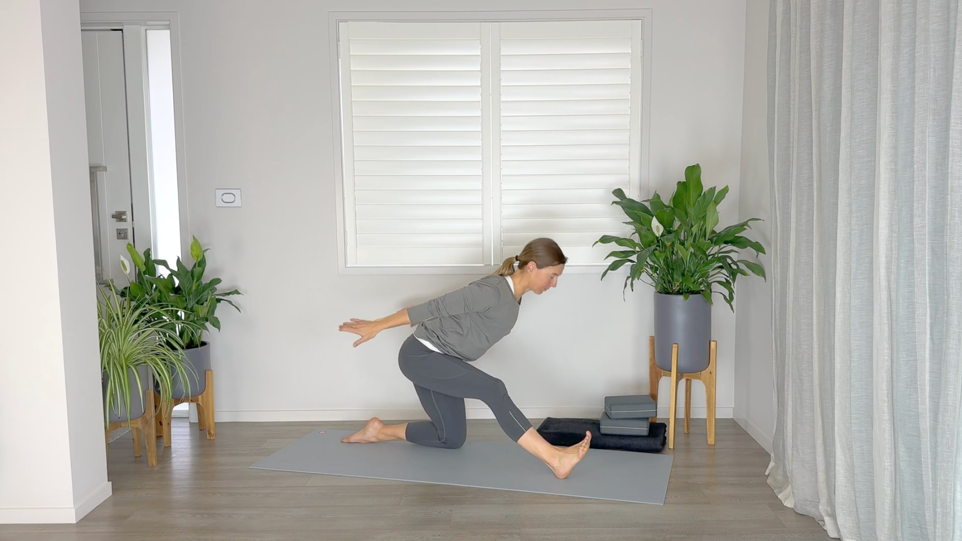 Woman in Half Splits on a yoga mat
