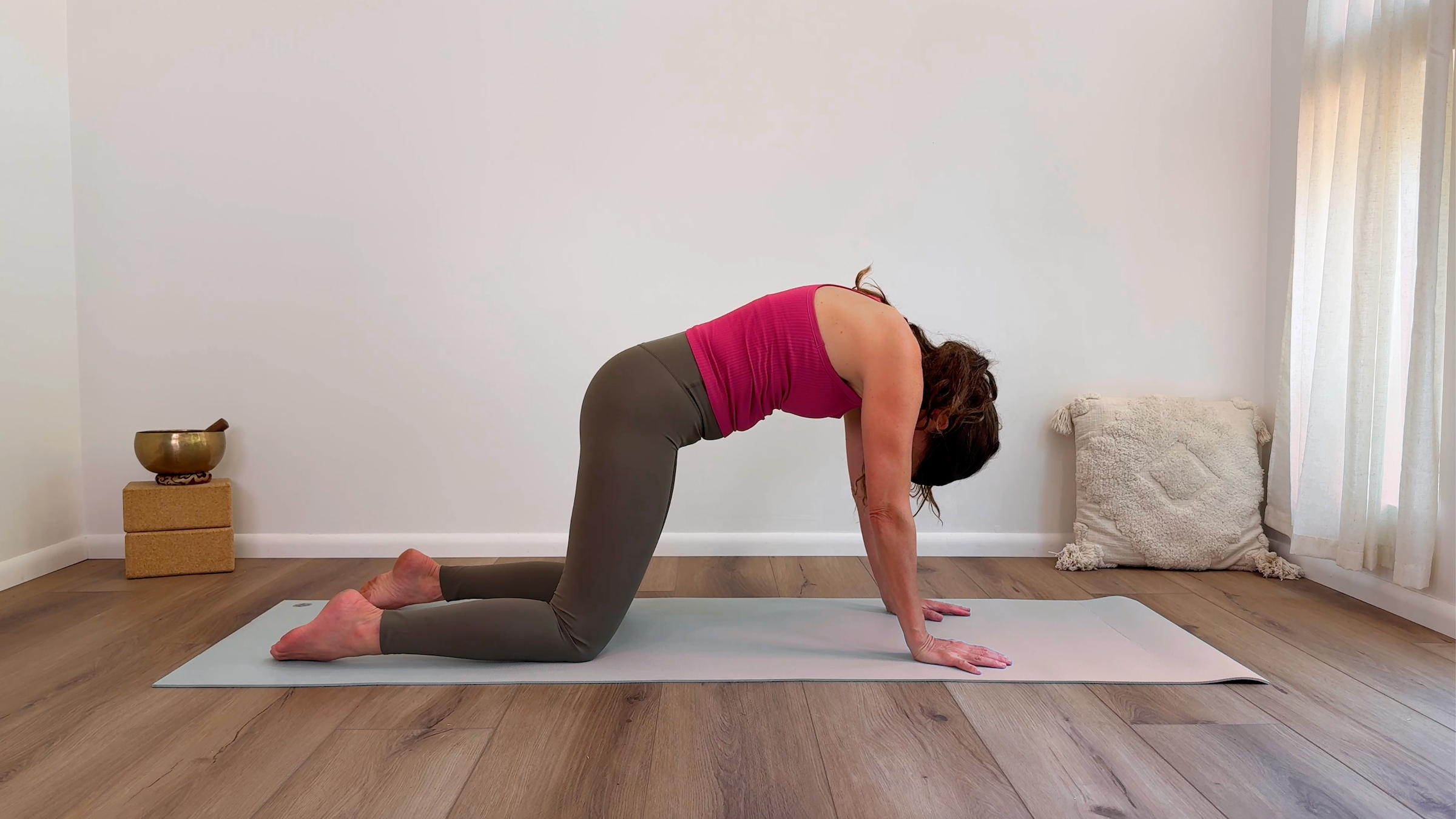 Yoga teacher Devi Daly in Cat Pose