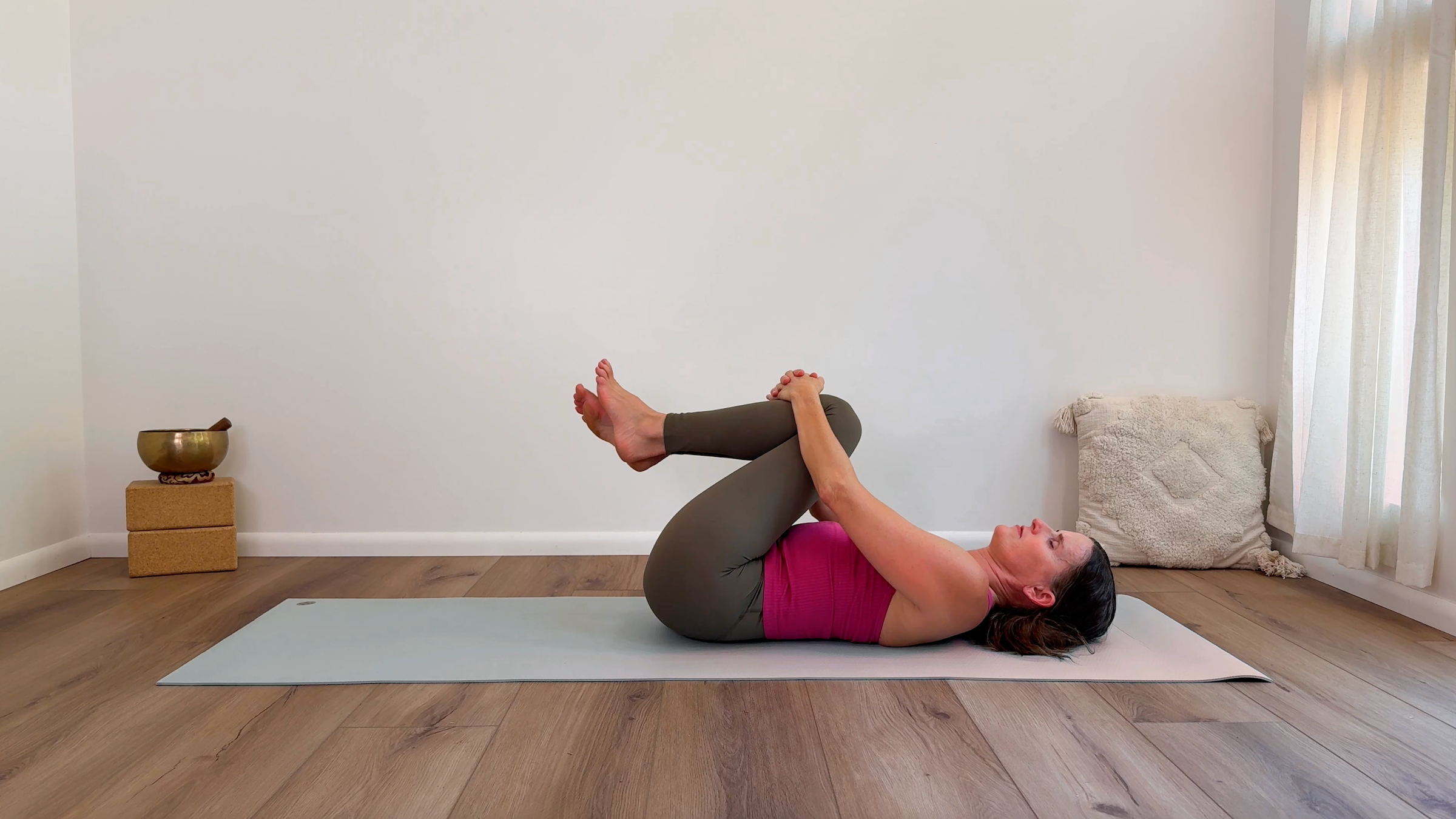 Yoga teacher Devi Daly in Knees to Chest