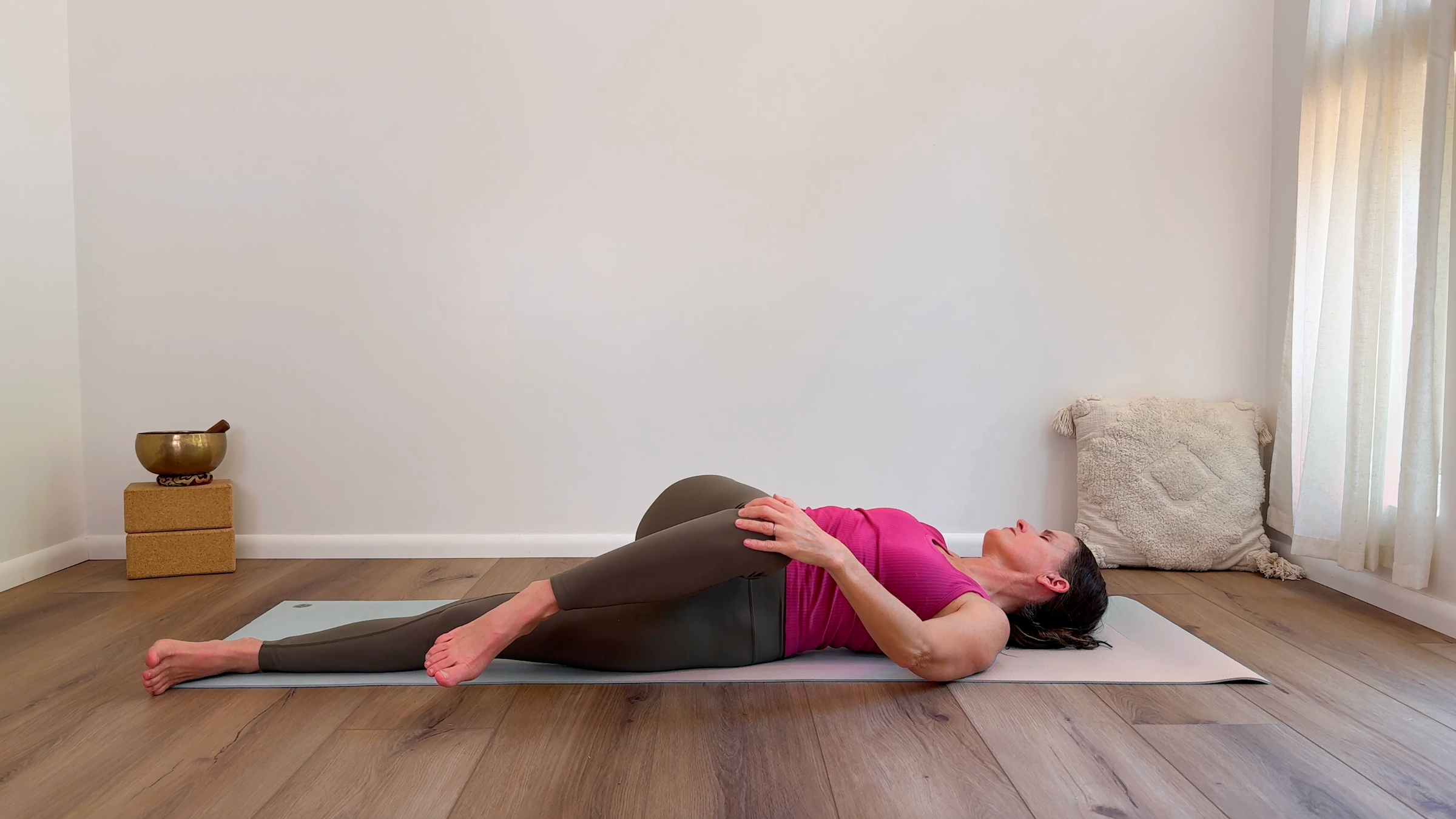 Yoga teacher Devi Daly leads a somatic yoga practice in Supine Twist