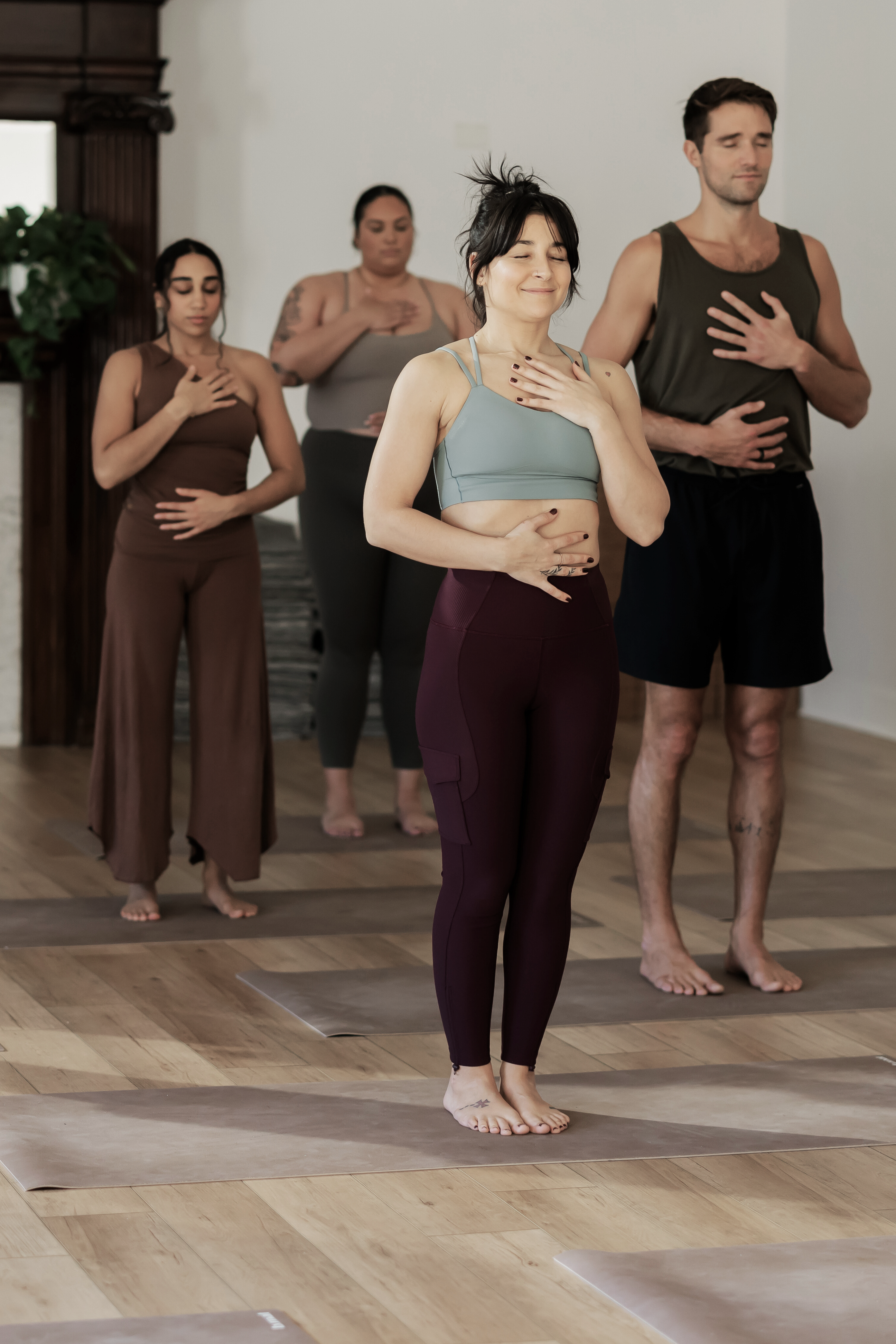 Yoga students in a class standing in Mountain Pose while spreading their toes