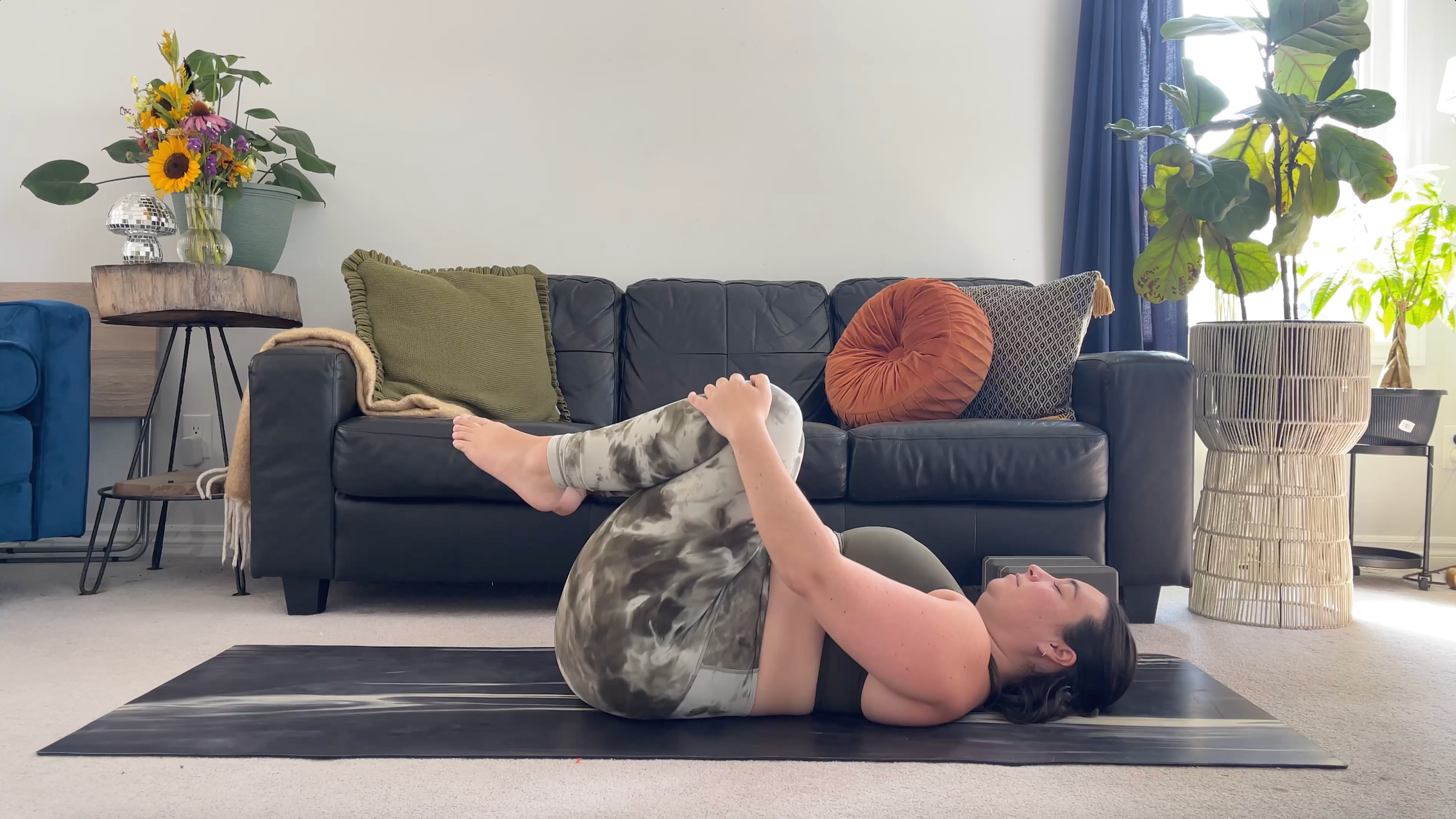 Yoga teacher Taylor Lorenz in Knees to Chest