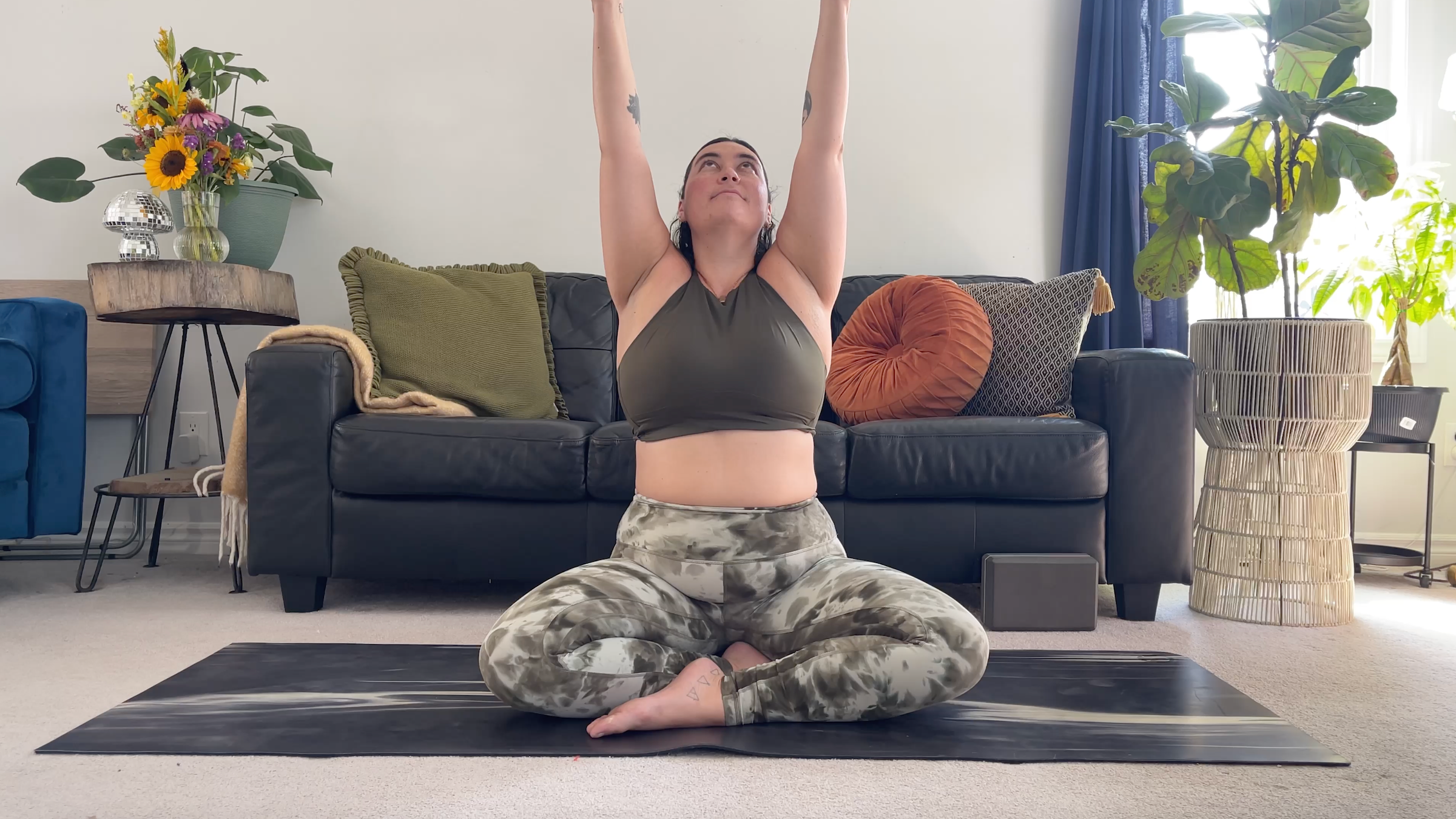 Yoga teacher Taylor Lorenz in Seated Upward Salute