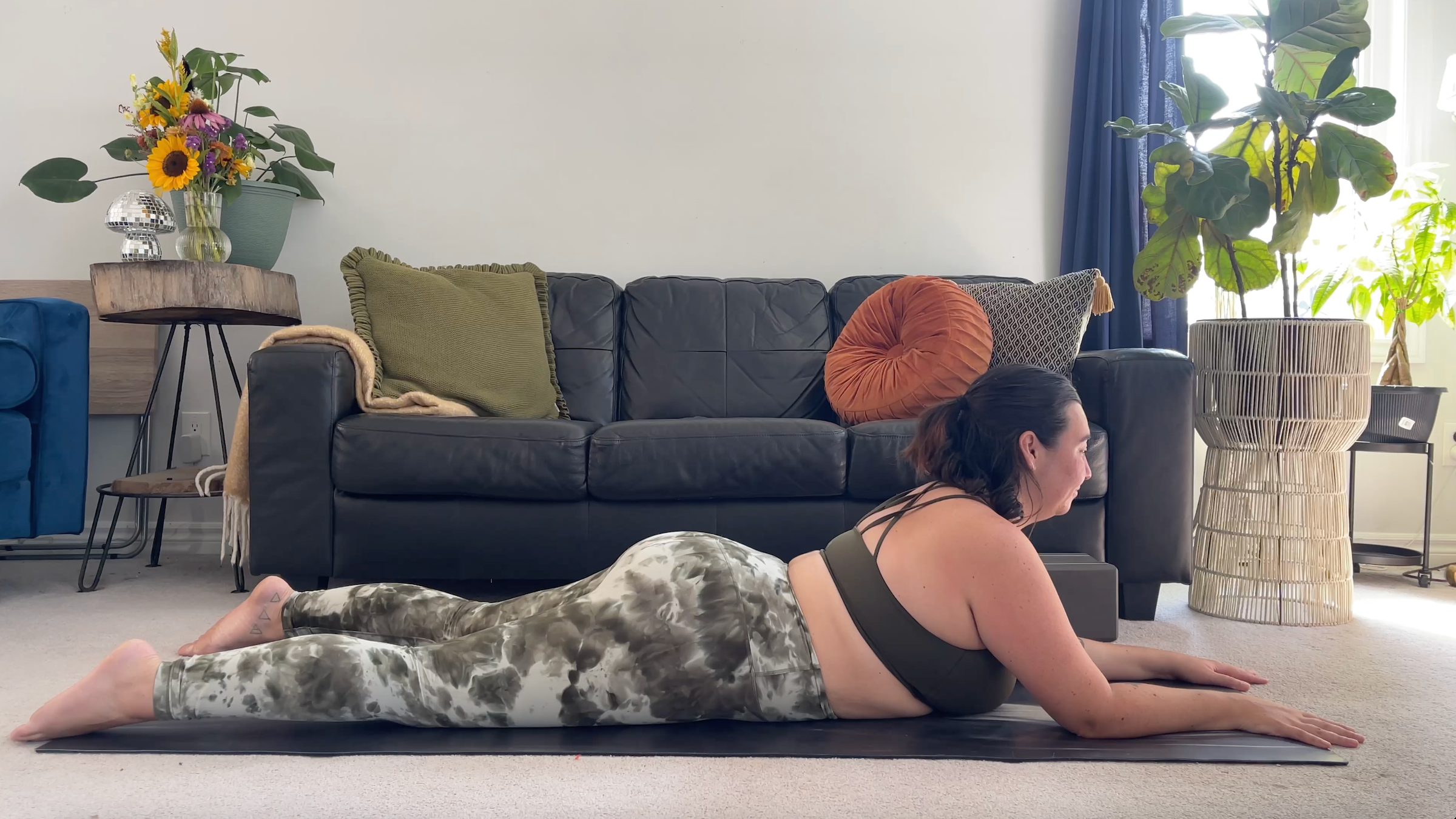 Yoga teacher Taylor Lorenz in Sphinx Pose, part of her yoga for back pain practice