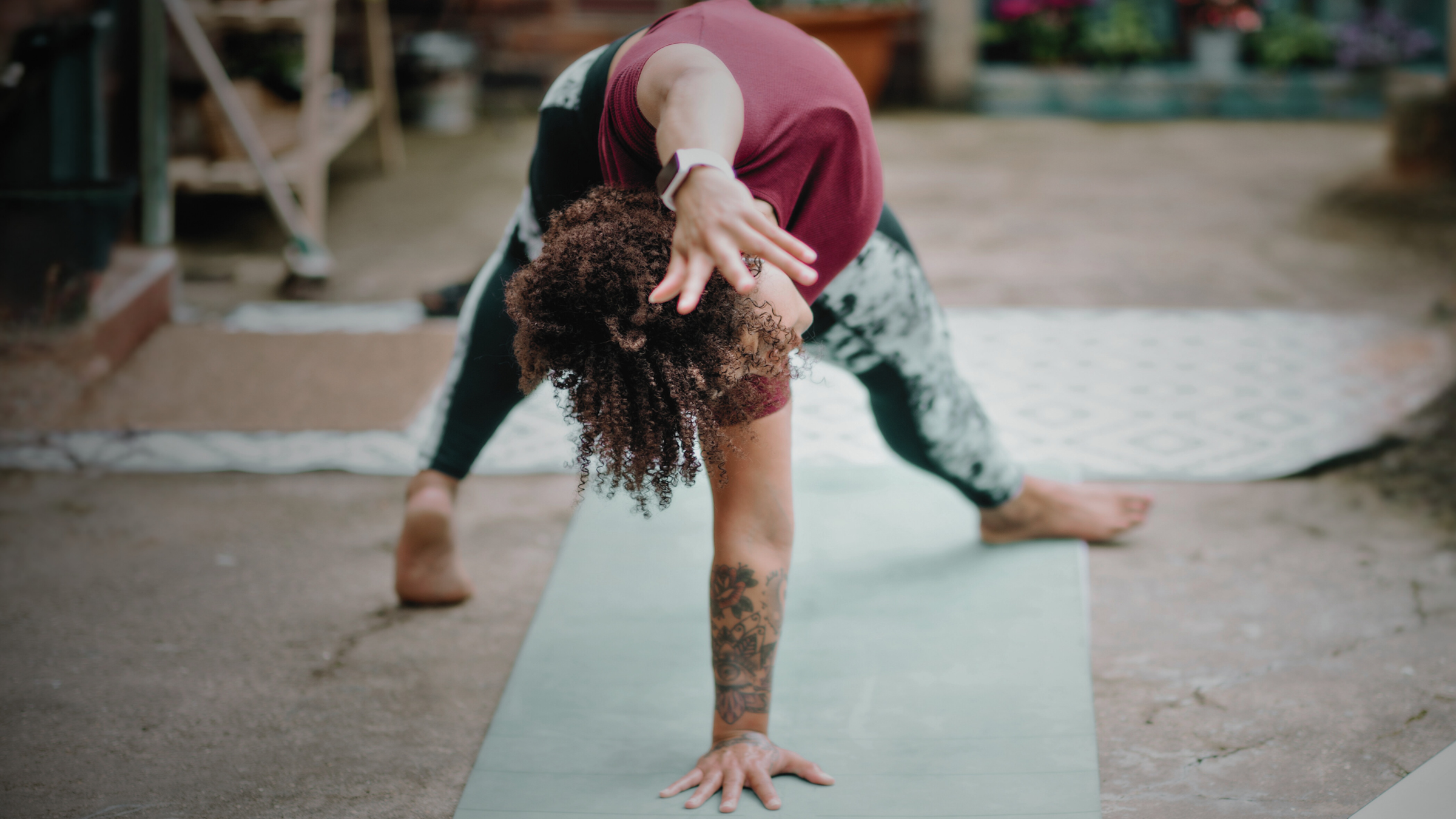 A woman practicing Wild Thing, a yoga pose, on a mat