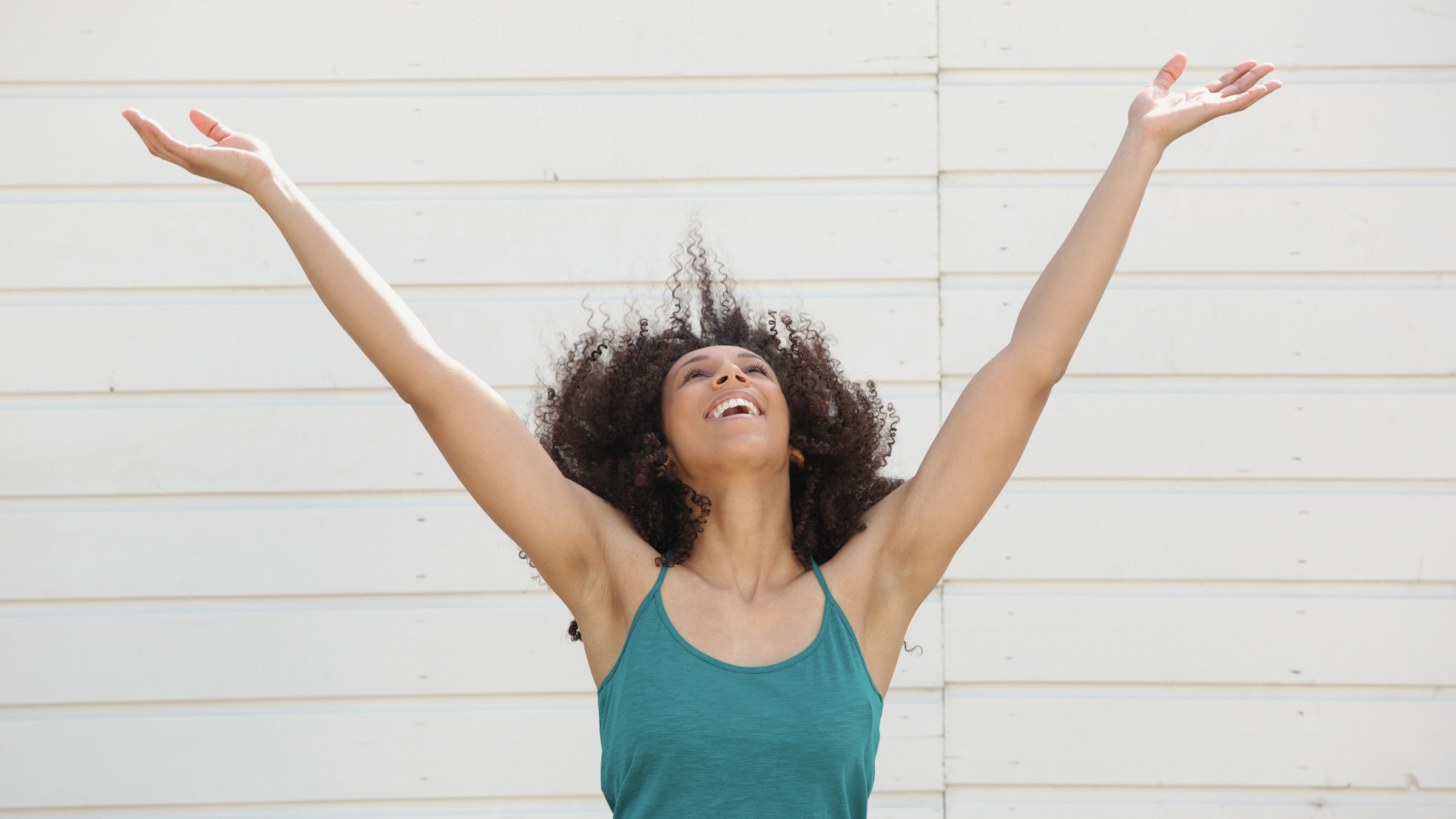 A woman with her hands in the air in celebration