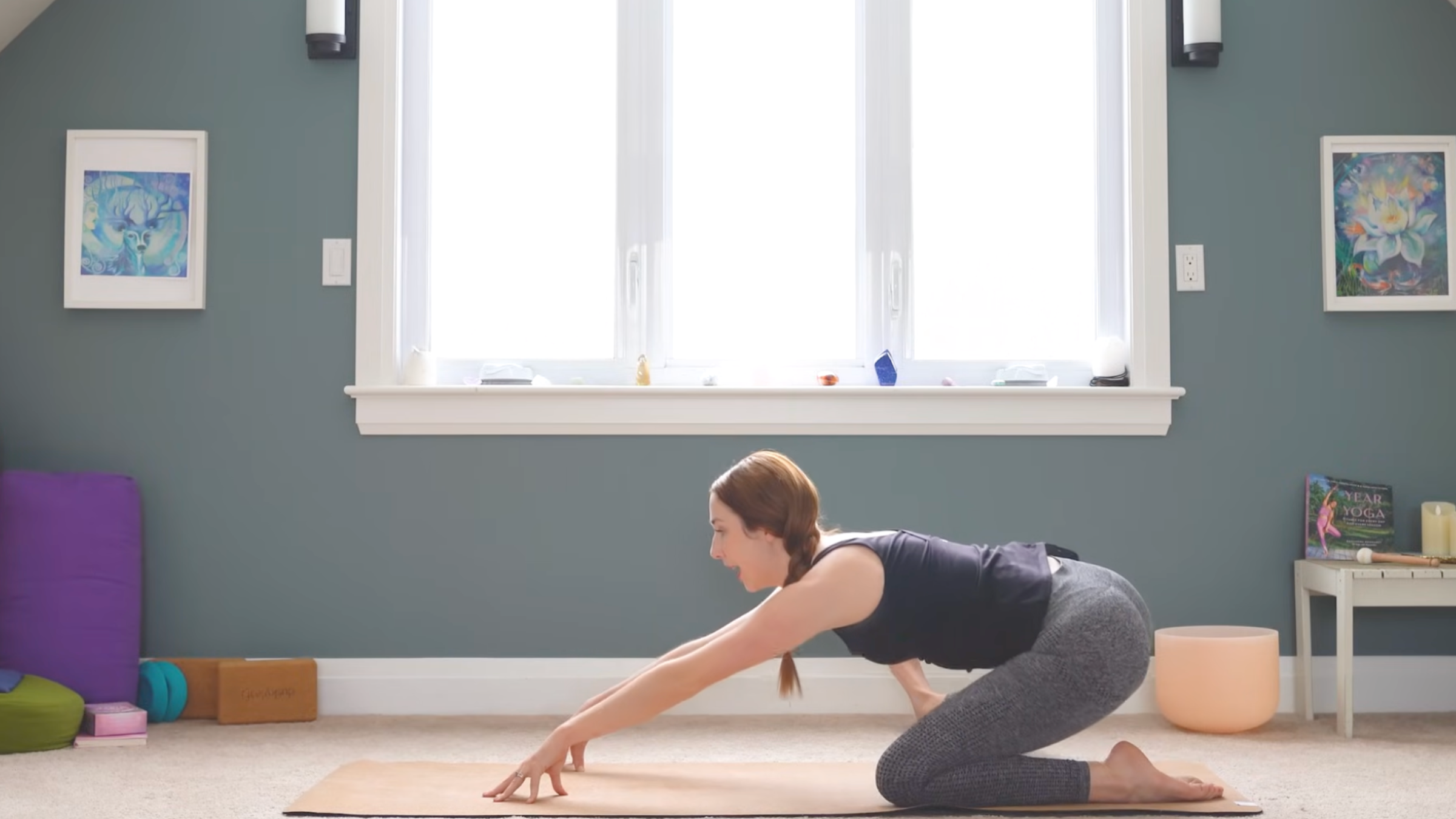 woman with legs in gate pose has hands extended forward with hands tented and fingertips touching mat during anterior pelvic tilt exercises