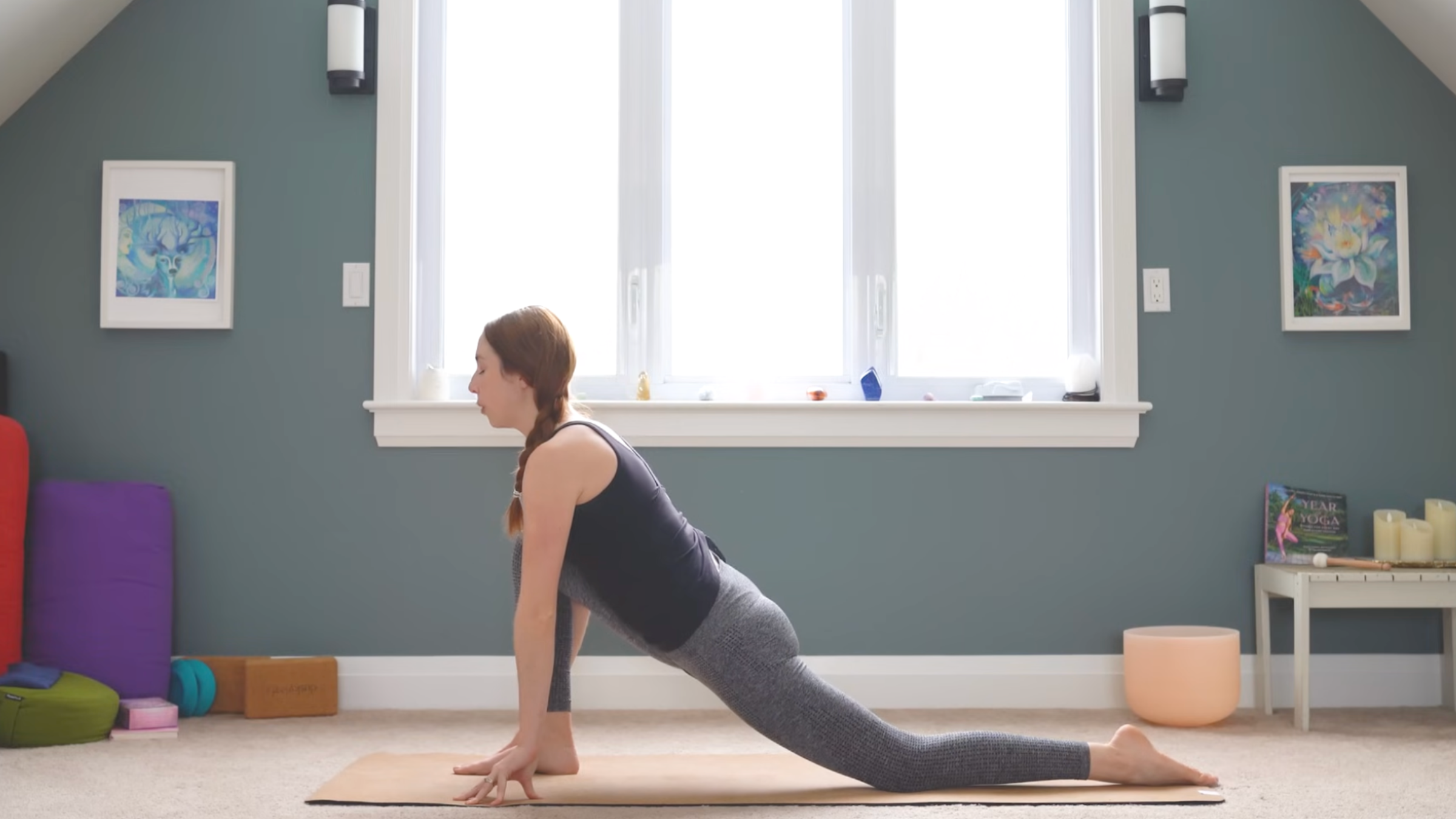 woman in low lunge legs on yoga mat with right leg forward, fingertips on mat and face looking forward during anterior pelvic tilt exercises