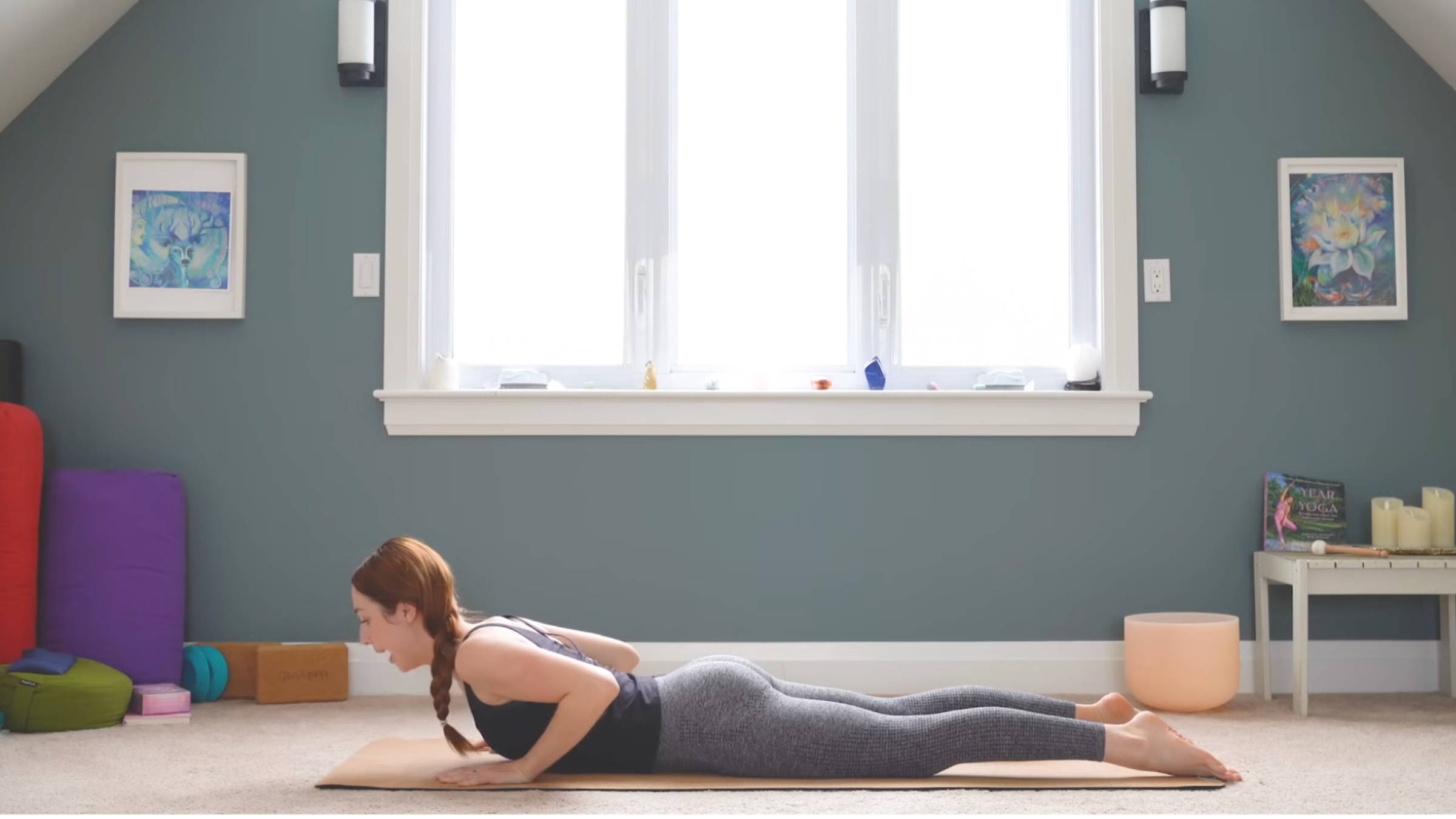 woman in cobra pose on yoga mat in home