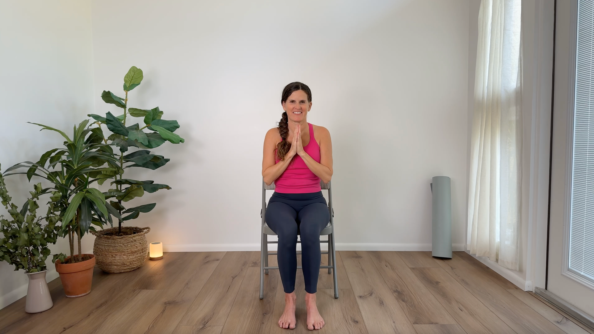 Teacher Devi Daly practicing chair yoga