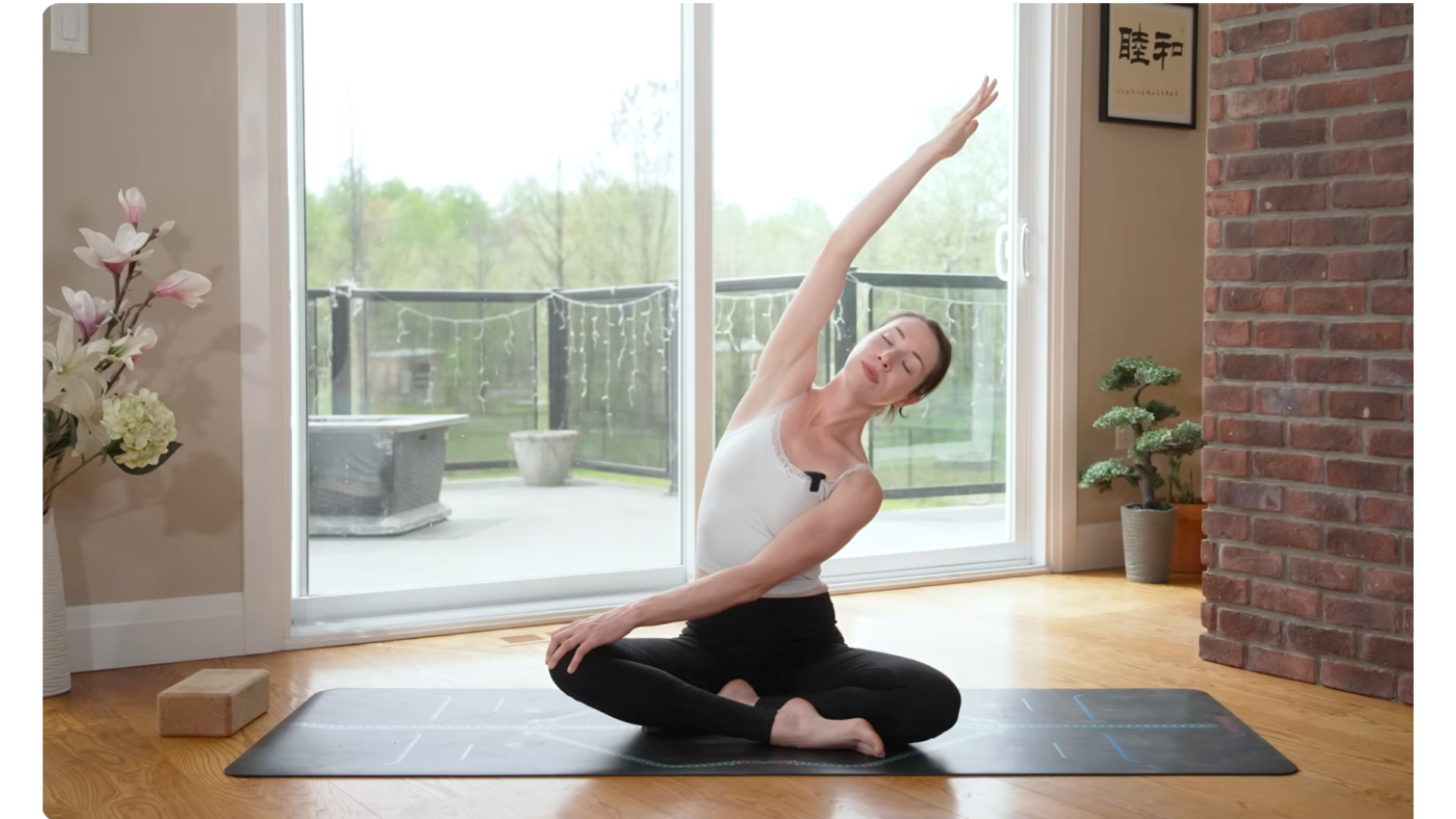 yoga teacher on a mat in a seated side stretch during gentle yoga for stress