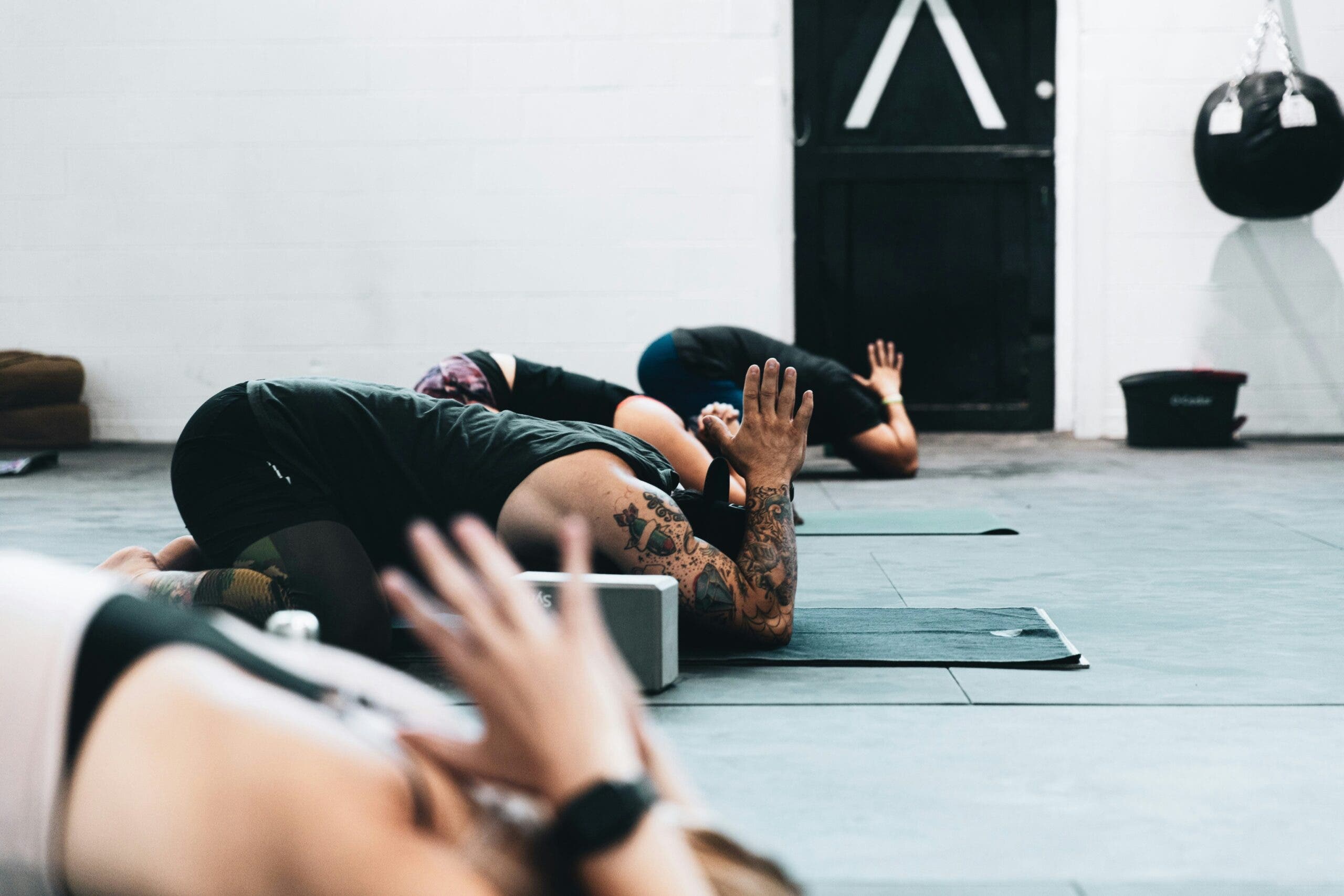 Image of yoga students in active Child's Pose.