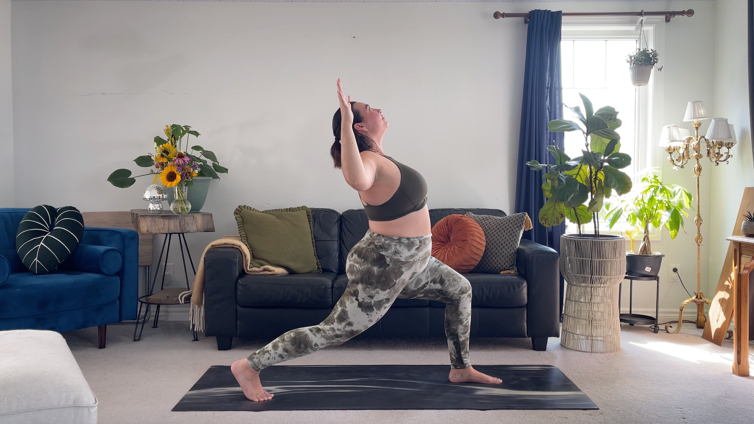 Yoga teacher Taylor Lorenz in Crescent Lunge with Cactus arms