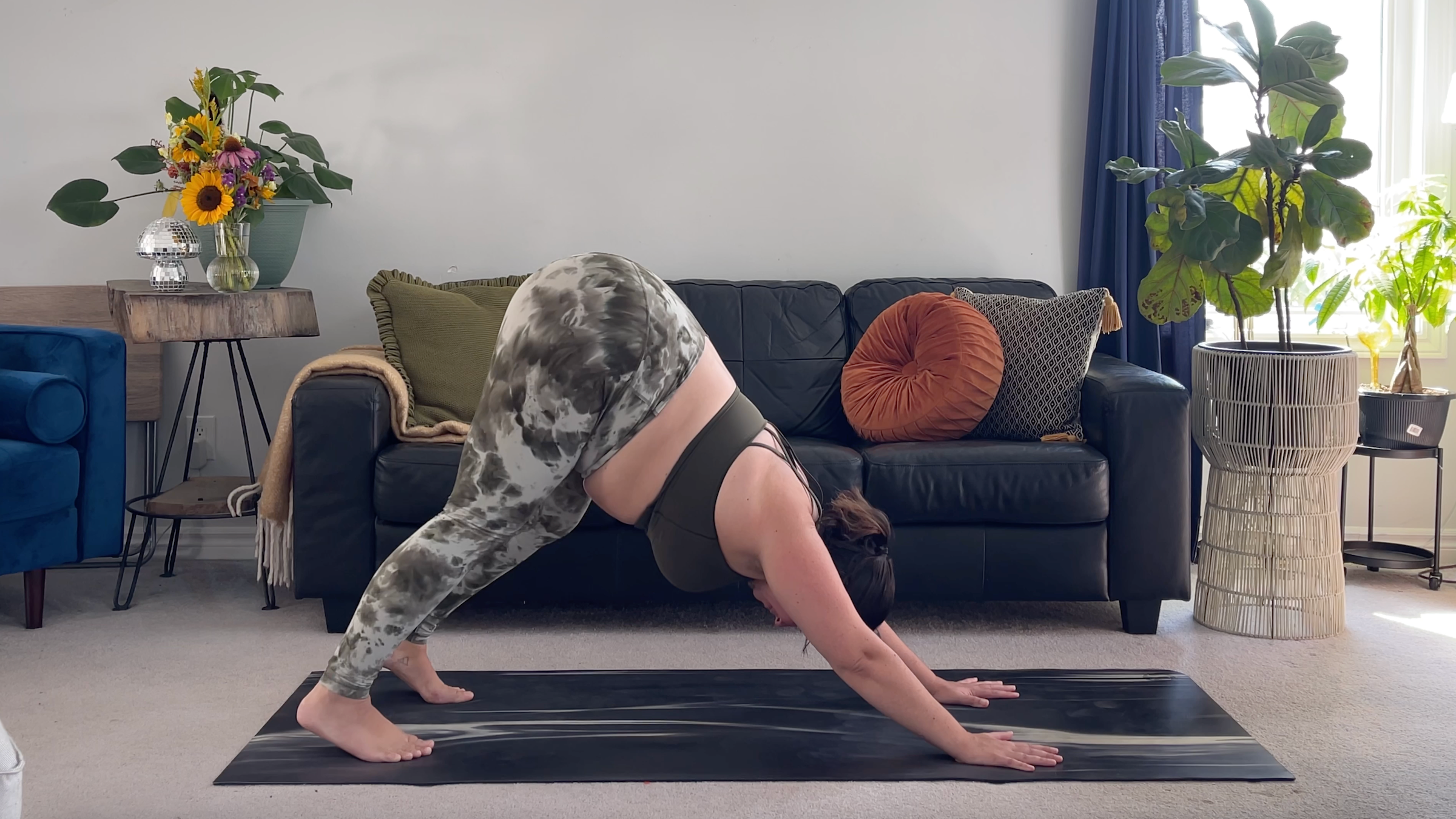 Yoga teacher Taylor Lorenz in Downward-Facing Dog