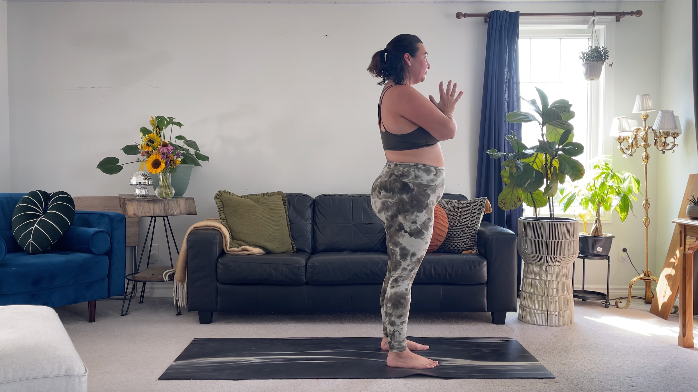 Yoga teacher Taylor Lorenz standing with hands to heart center