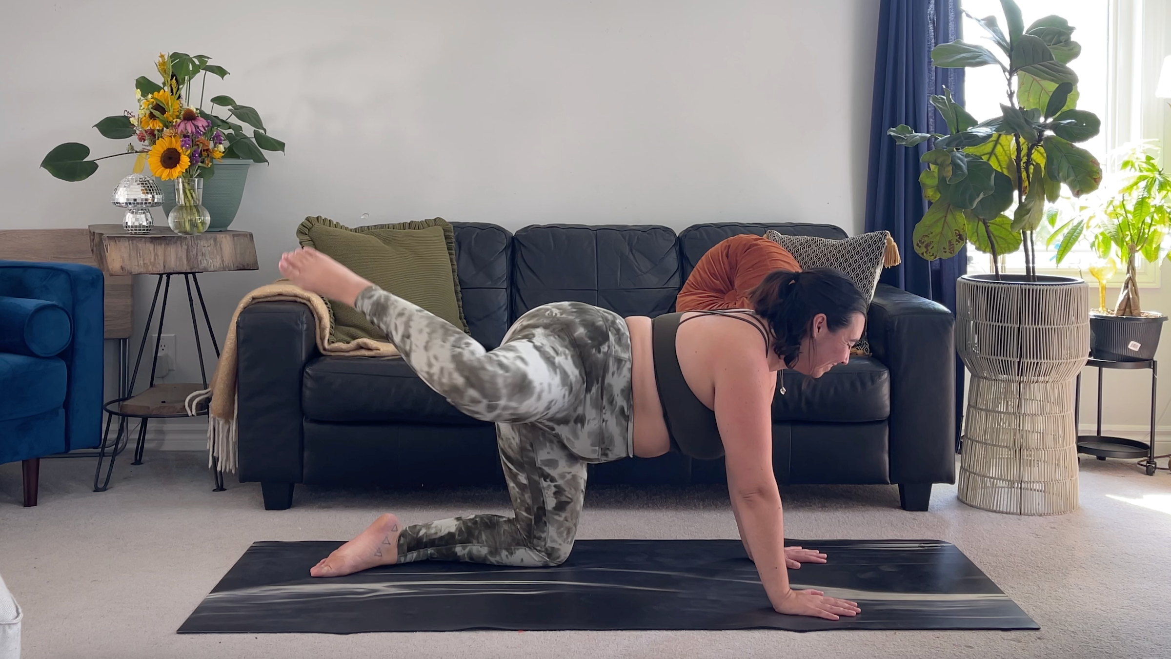 Yoga teacher Taylor Lorenz doing knee circles on a yoga mat