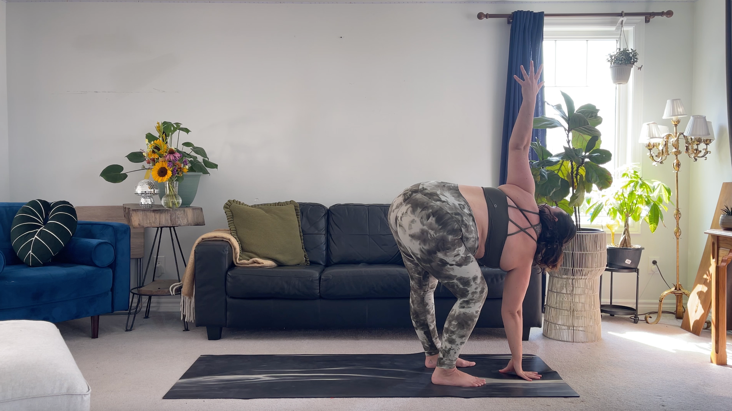 Yoga teacher Taylor Lorenz in Revolved Standing Forward Bend