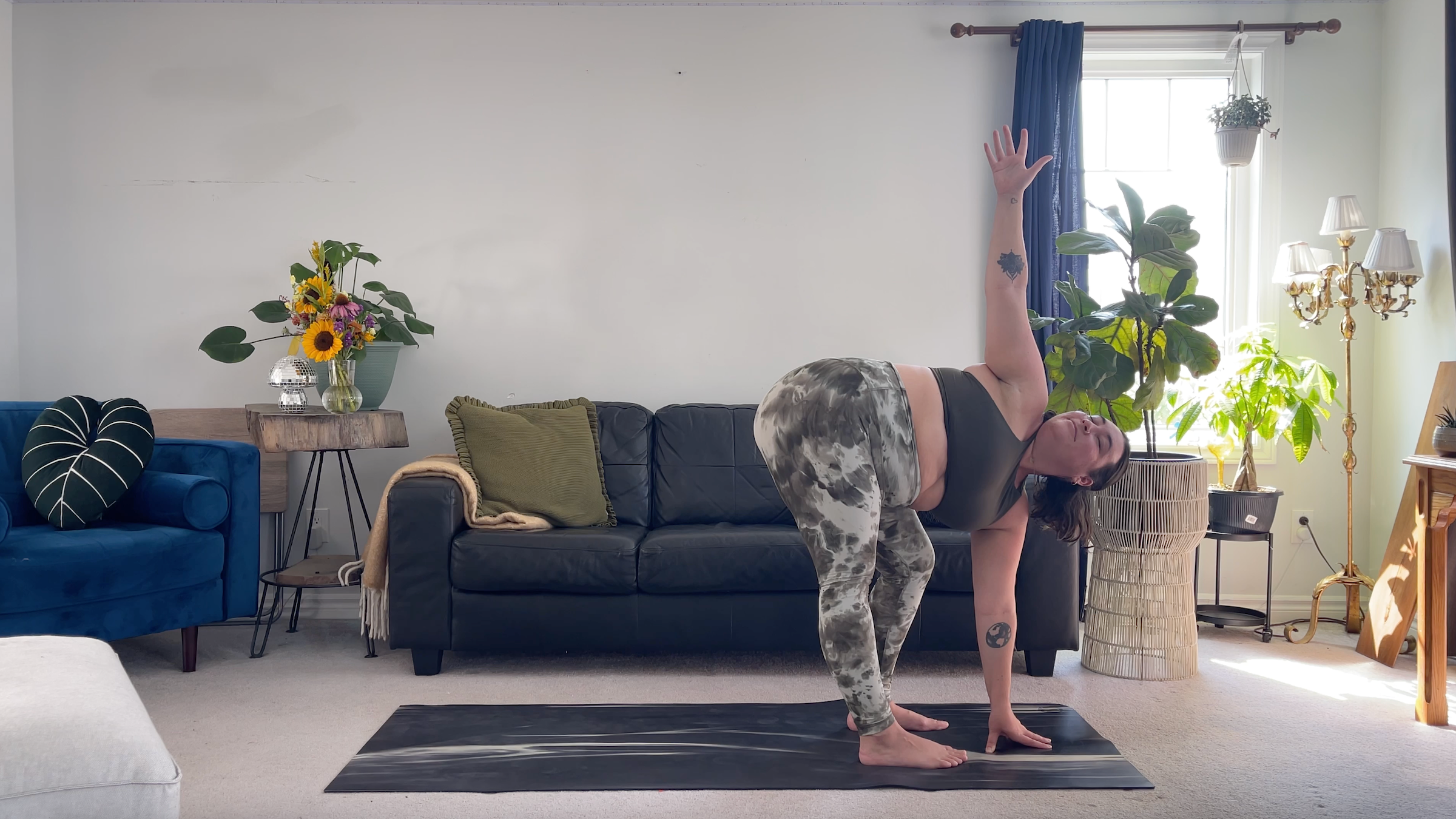 Yoga teacher Taylor Lorenz in Revolved Standing Forward Bend