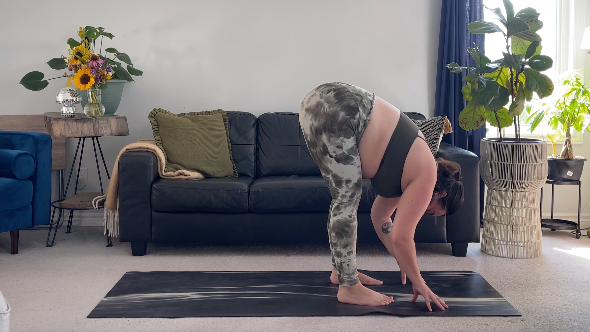 Yoga teacher Taylor Lorenz in Standing Forward Bend