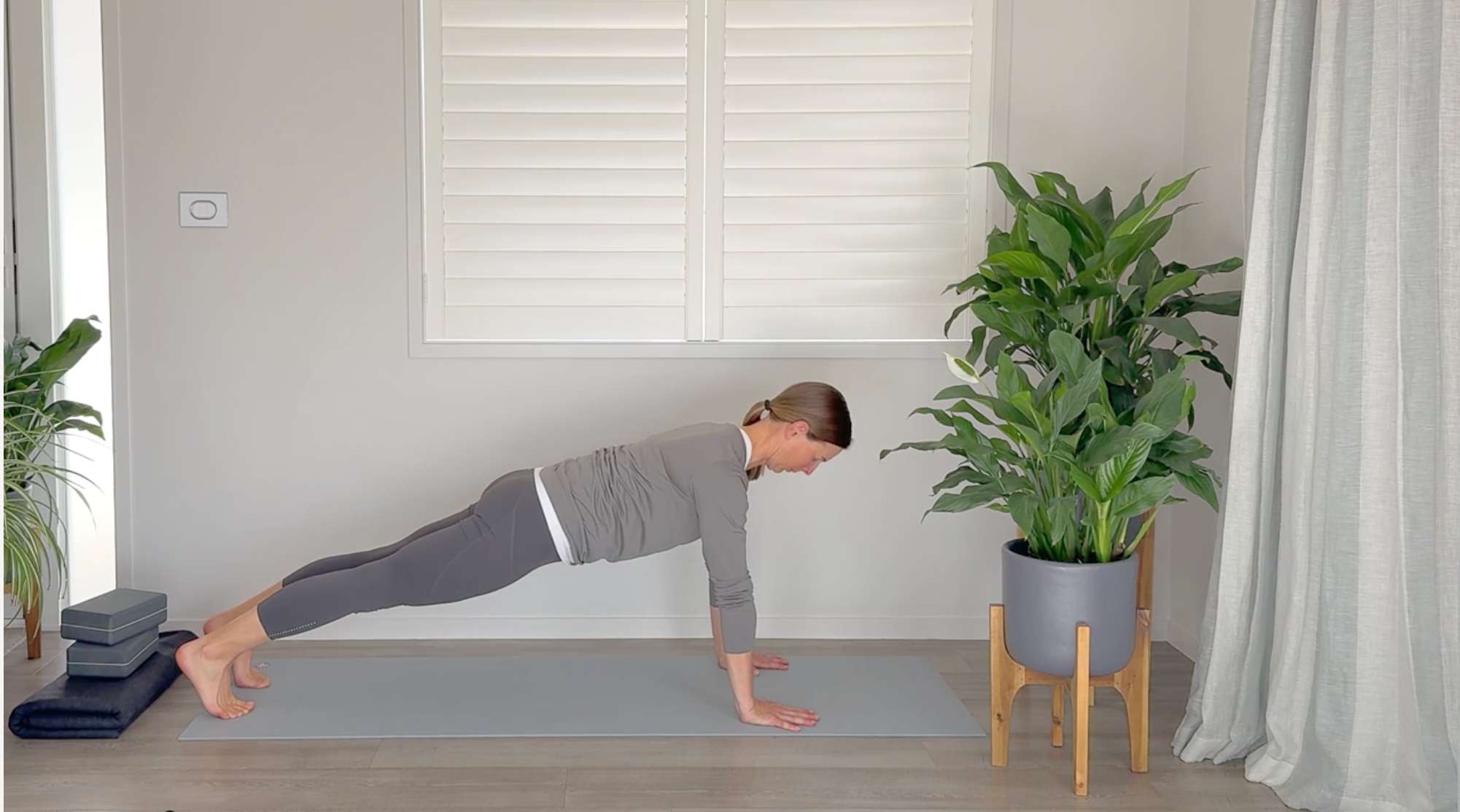 Woman in Plank Pose with her head and neck in safe alignment with the rest of her spine