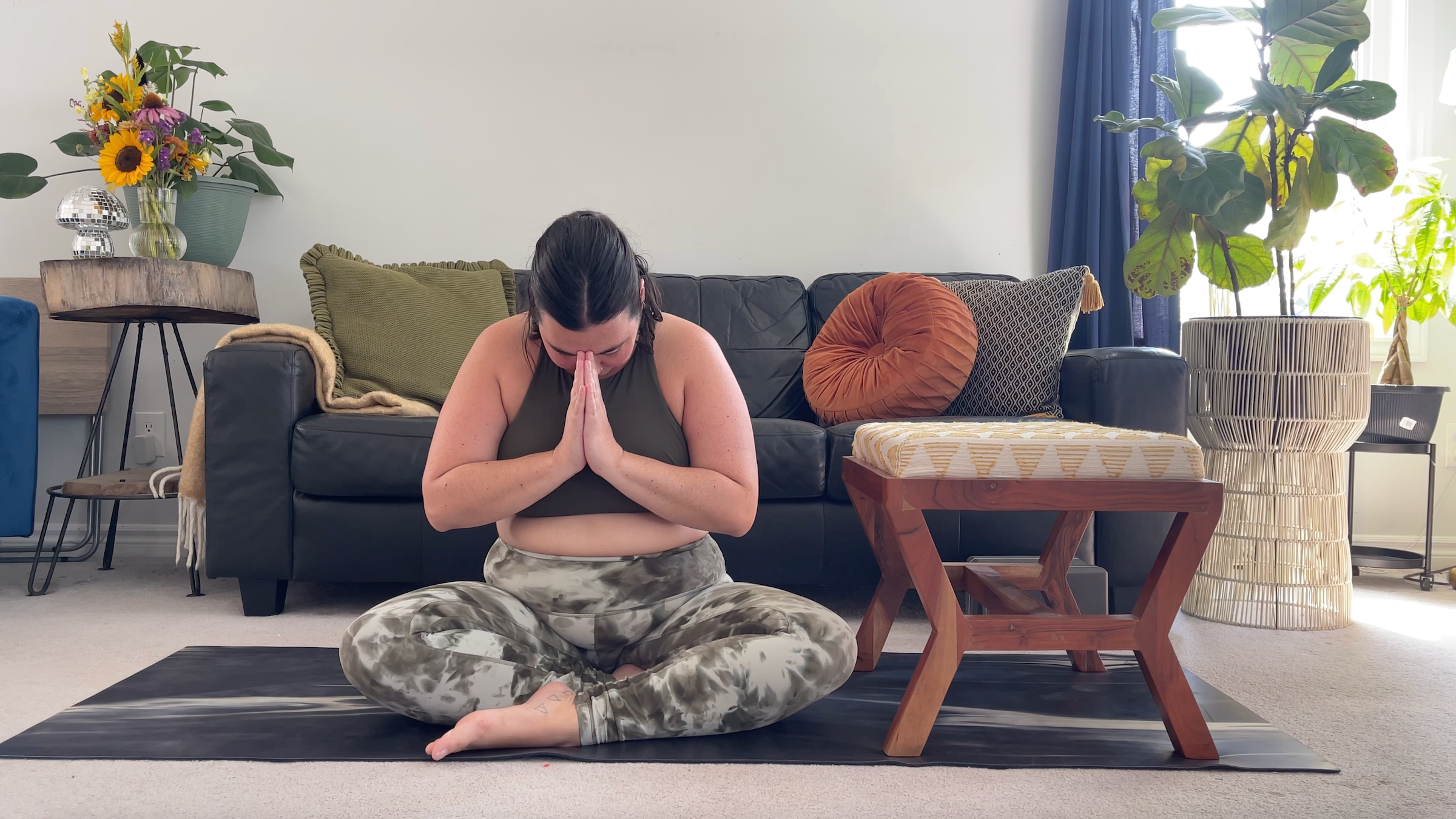 Yoga teacher Taylor Lorenz in Easy Pose, part of her guided Savasana