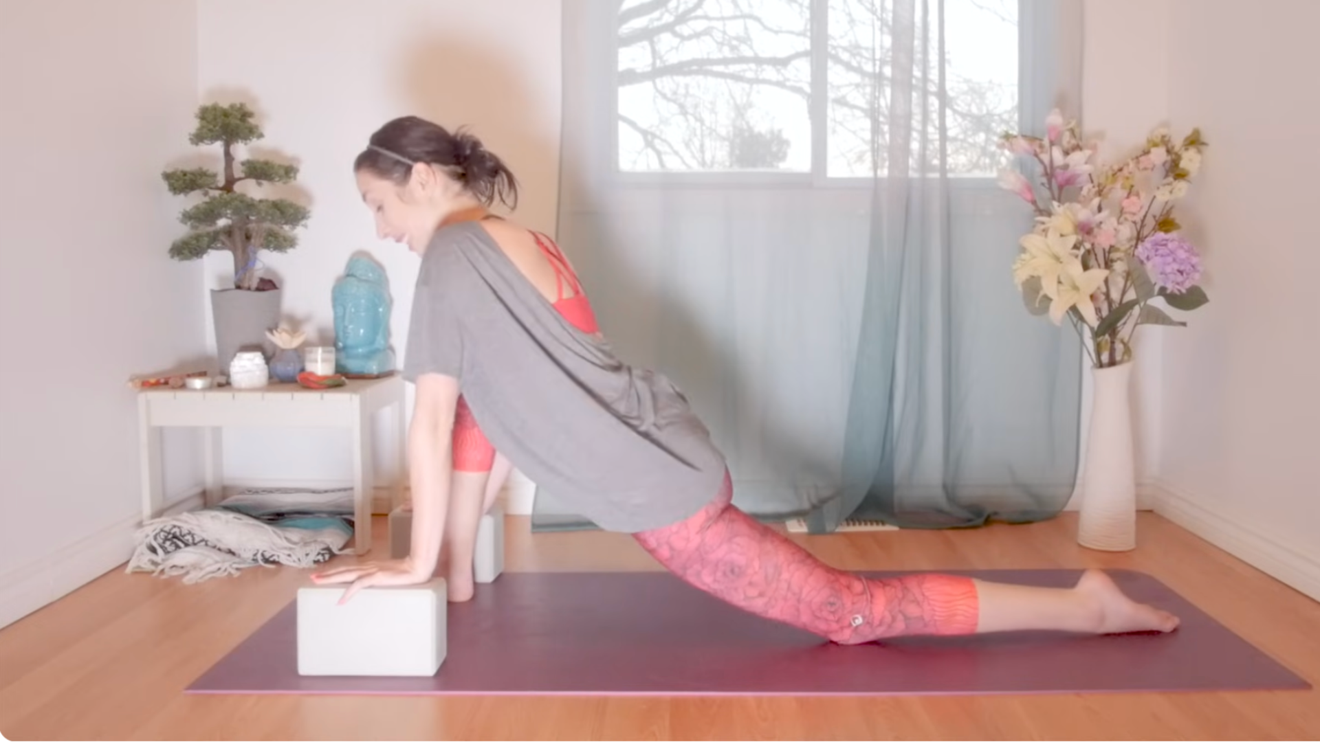 Yoga teacher in Dragon Pose, the yin yoga version of Low Lunge.