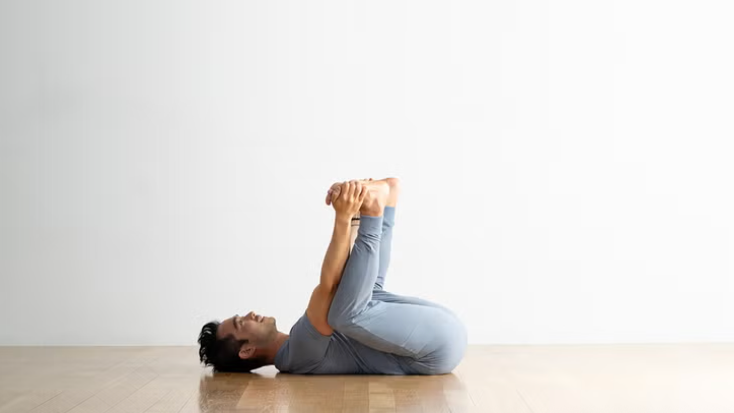 A yoga teacher in Happy Baby