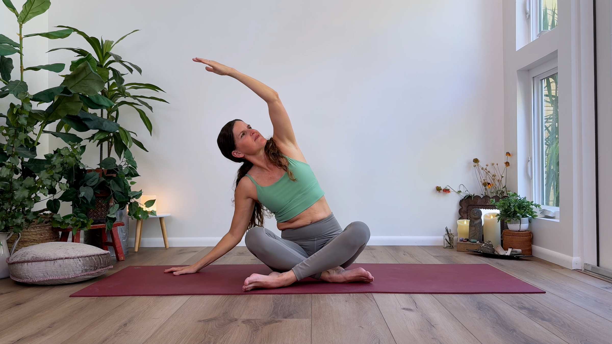 Teacher Devi Daly in Seated Side Stretch