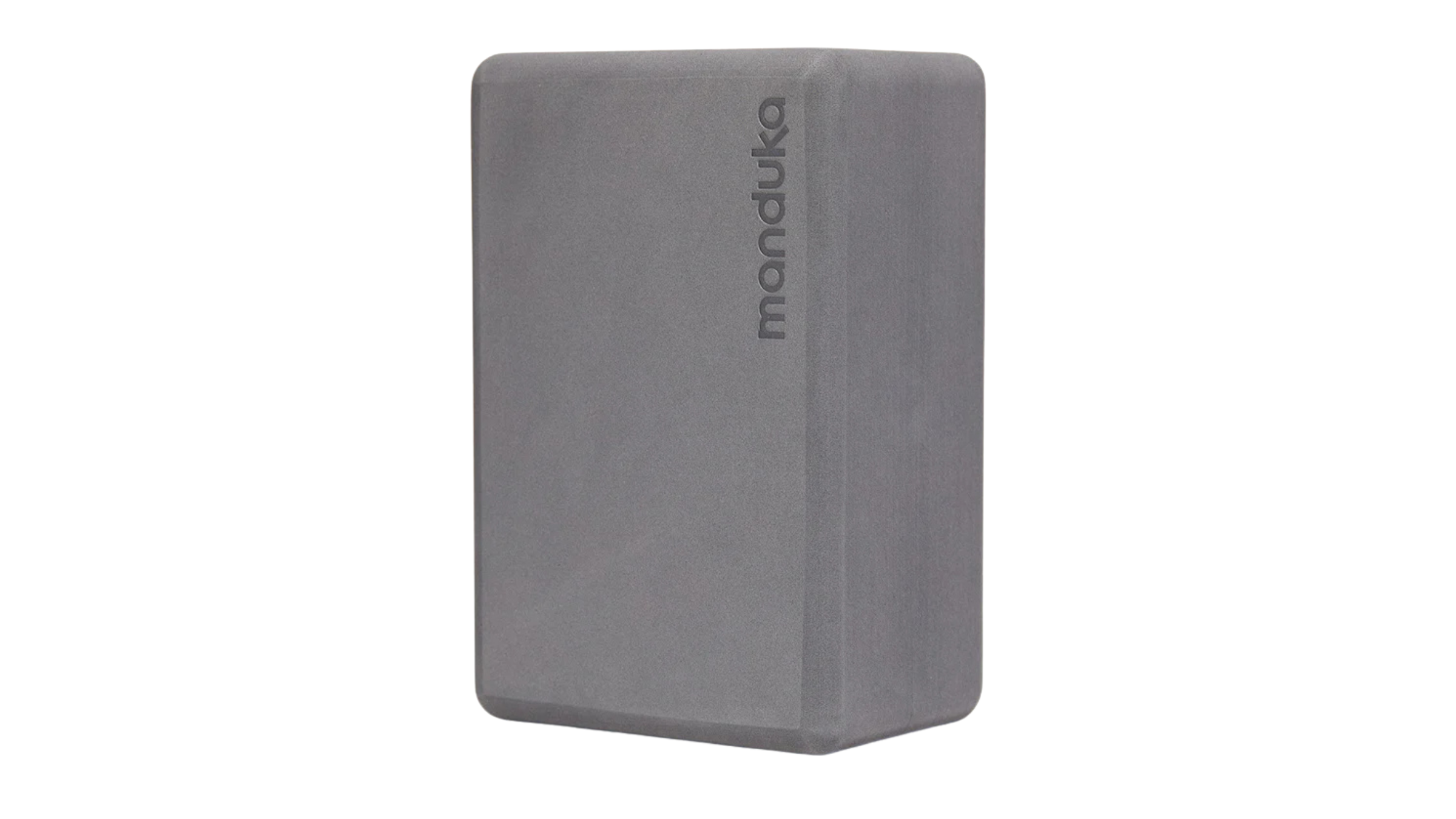 gray foam yoga block on white background