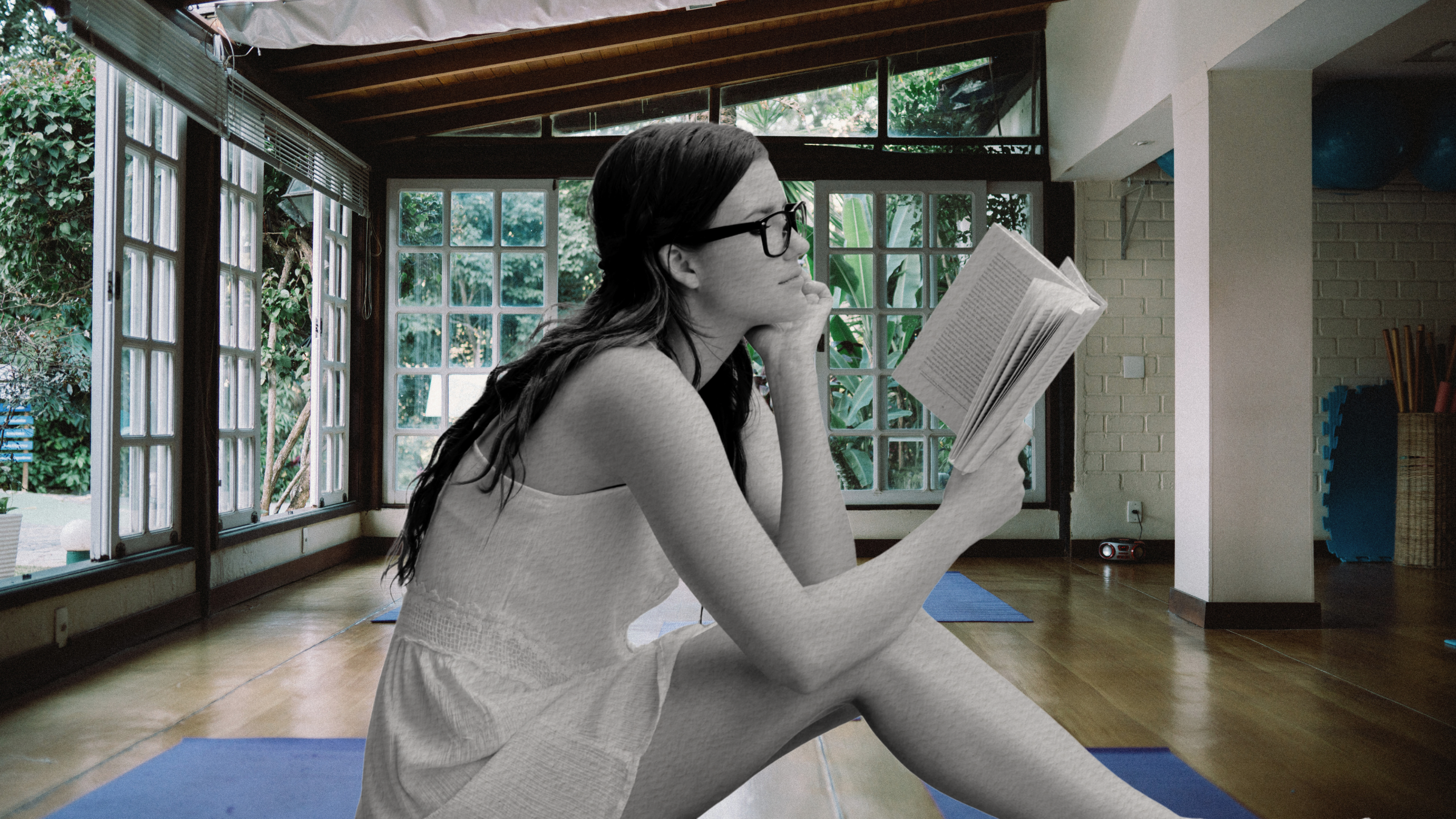 A woman reading in a yoga studio